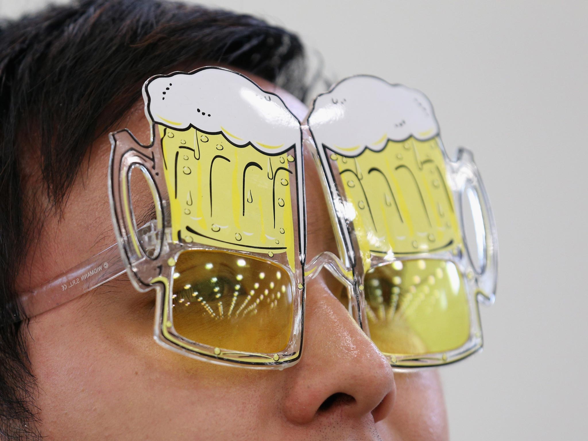 Phai Dip wears novelty, beer-related glasses at the Great British Beer Festival in the Olympia exhibition centre in London