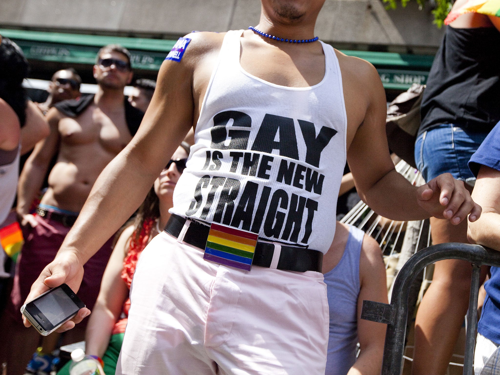 A man wears a shirt that reads 'gay is the new straight' during the New York City Gay Pride March on June 24, 2012 in New York City. The annual civil rights demonstration commemorates the Stonewall riots of 1969, which erupted after a police raid on a gay bar, the Stonewall Inn on Christopher Street.