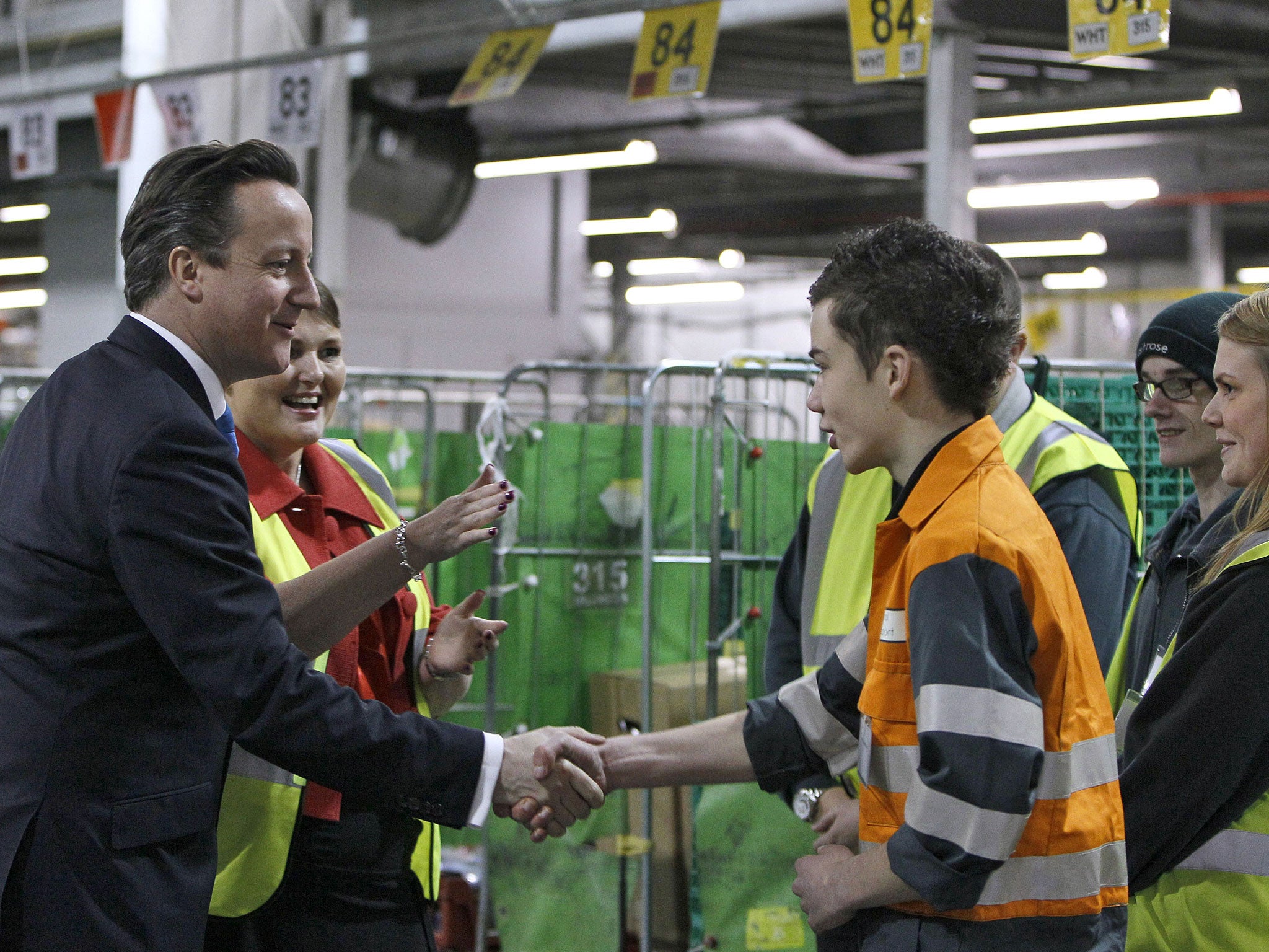 David Cameron shakes hands with a young apprentice during a visit to Waitrose