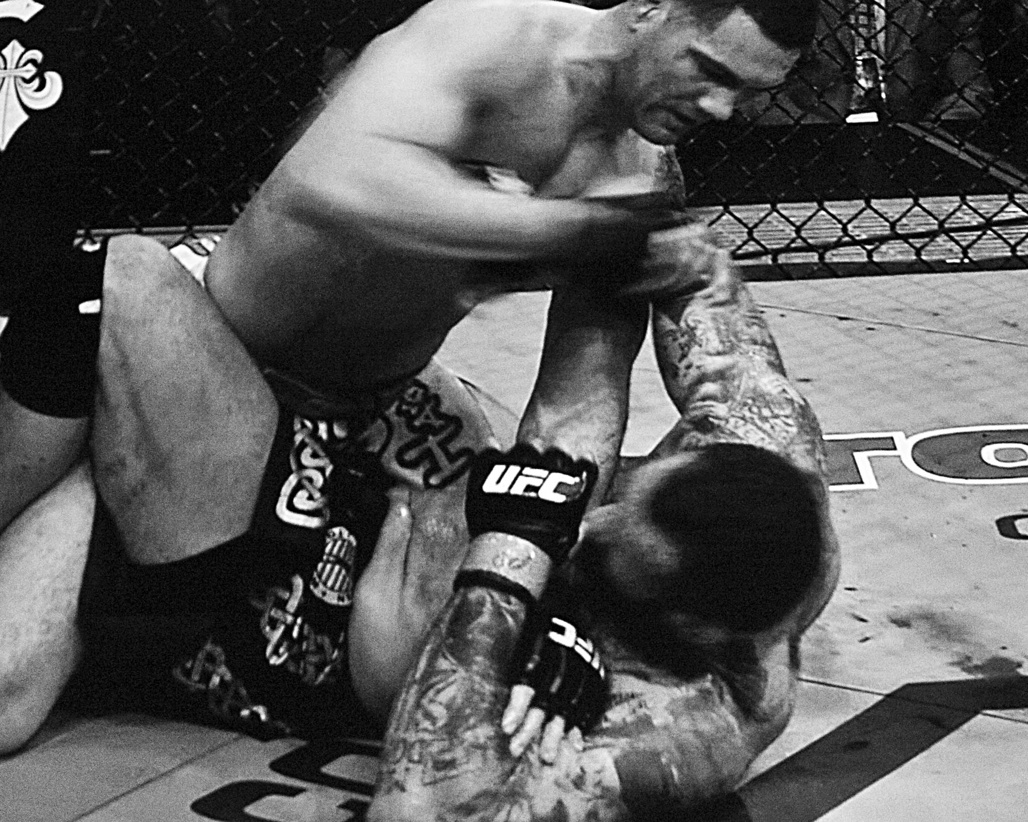 Videos of past UFC bouts play on big screens at the weigh-in and lobby of the MGM Grand, promoting upcoming fights: pictured here Chris Weidman (on top) in a previous fight