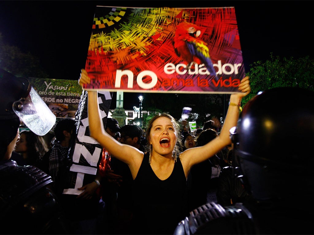 Demonstrators protest against the decision to drill for oil in the Amazon and, below, President Correa’s TV address