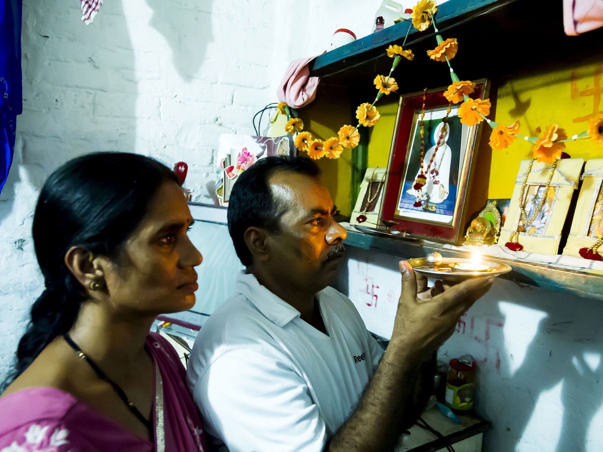 The victim’s parents at a shrine for their daughter
