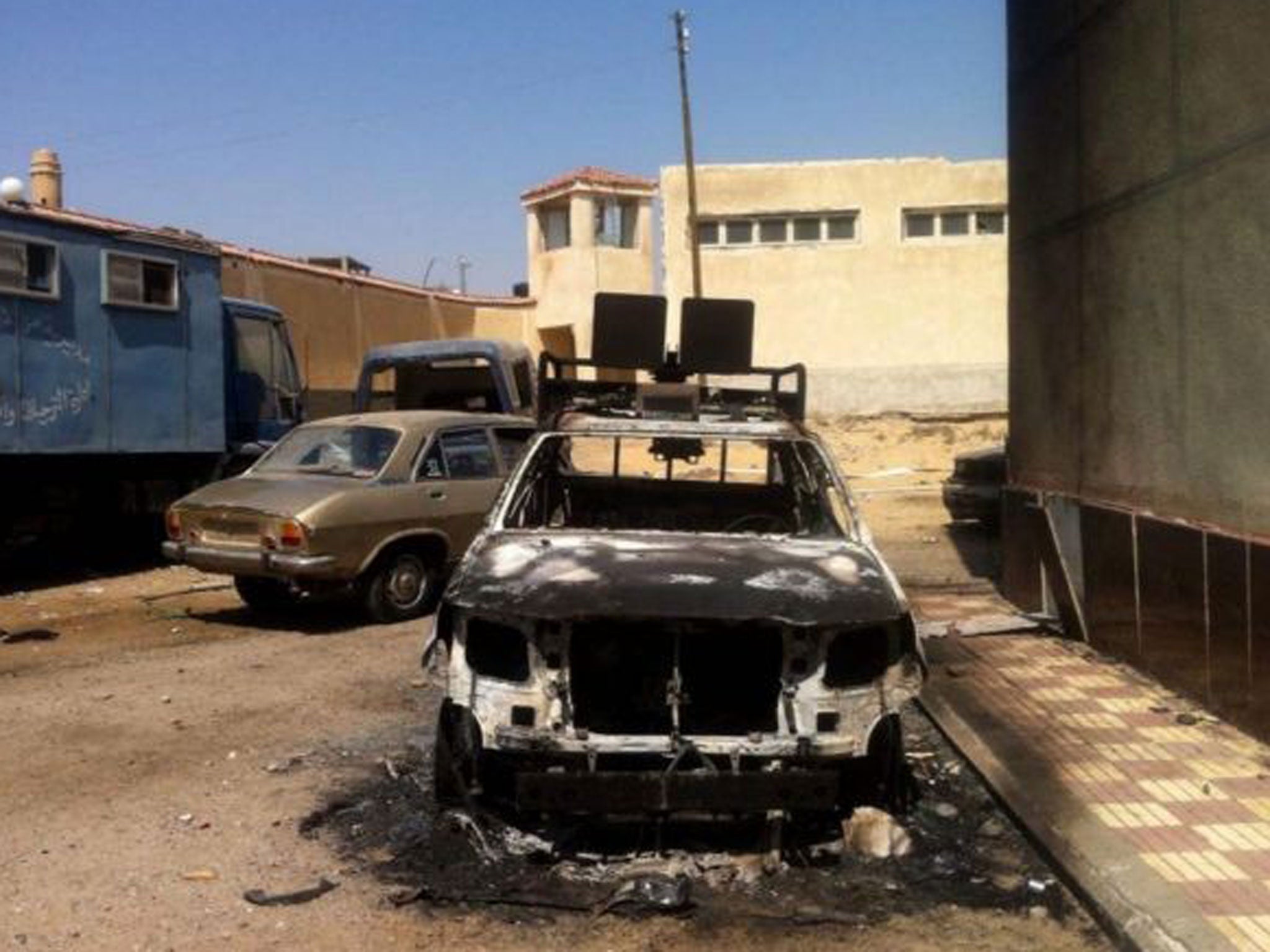 A view of charred security forces vehicles which were burned after an attack by protesters supporting ousted president Morsi overnight in the north Sinai town of al-Arish. Attacks have been happening daily