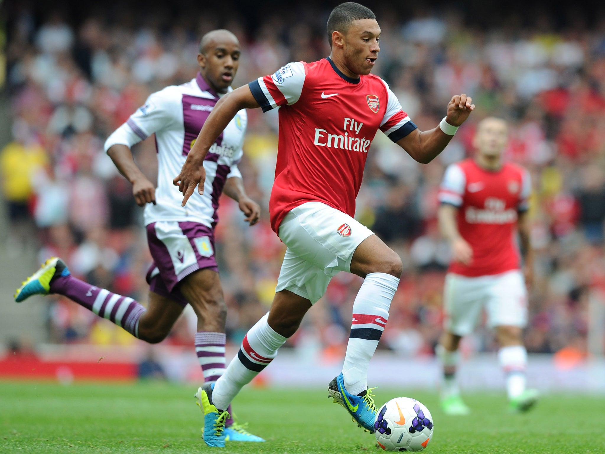 Alex Oxlade-Chamberlain in action against Aston Villa before being taken off with a knee injury