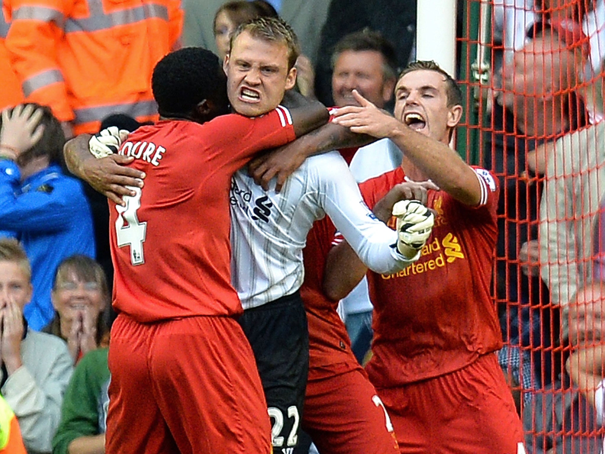 Jordan Henderson celebrates with Simon Mignolet after the keeper saves a penalty against Stoke