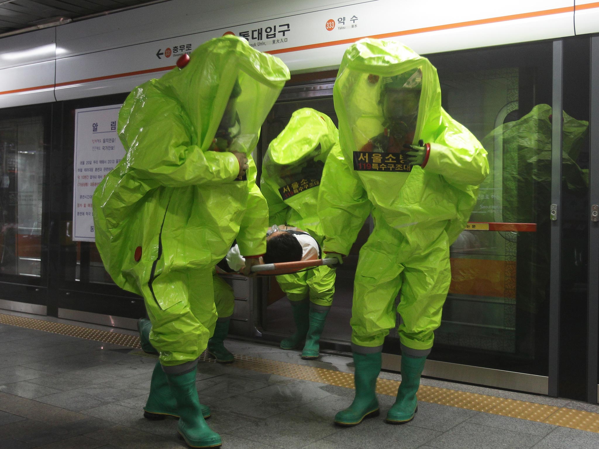 Emergency services personnel wearing protective clothing participate in an anti-terror and anti-chemical drill session held as part of the Ulchi Freedom Guardian (UFG) exercise