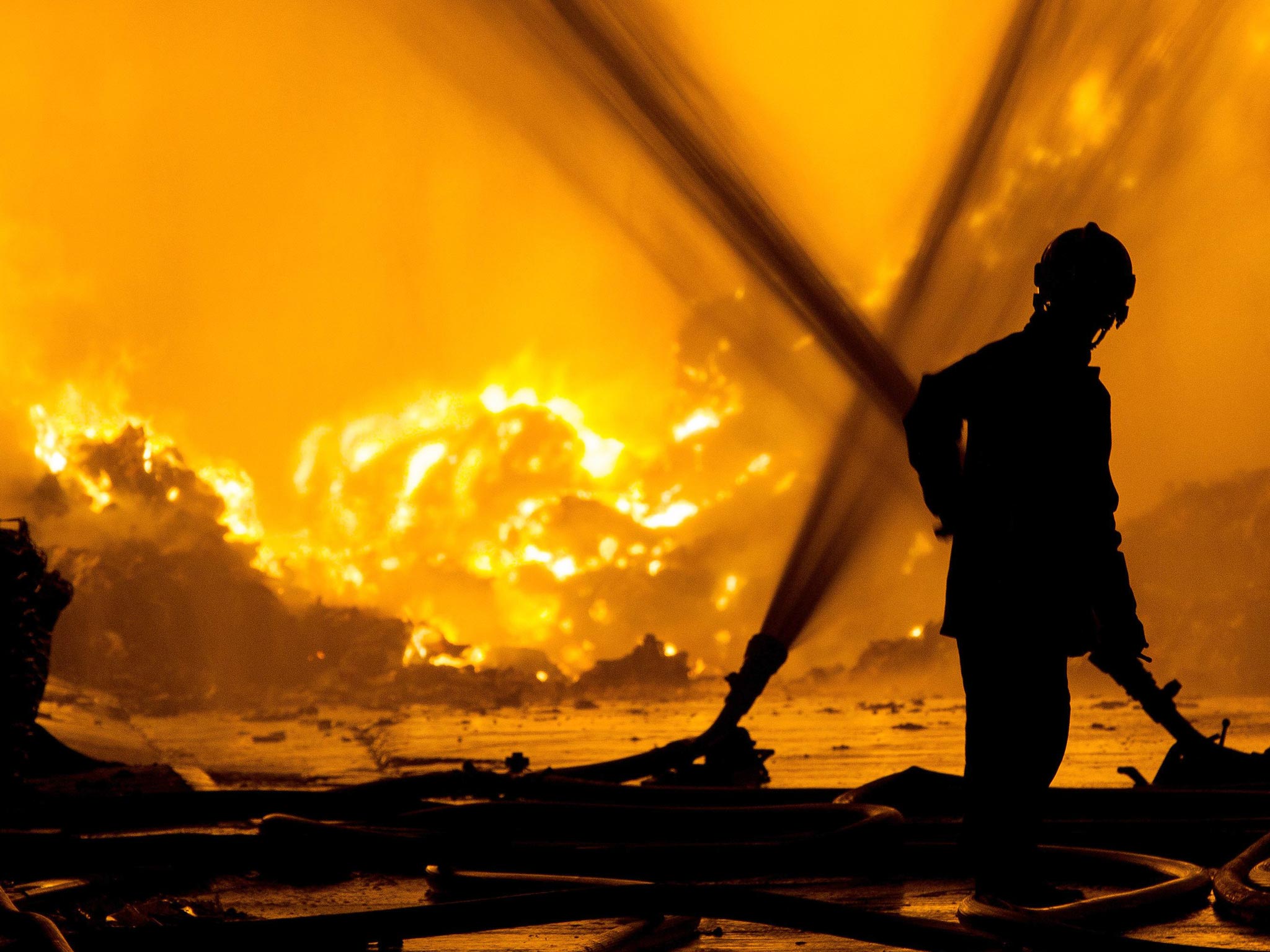 A fireman looks at the blaze at Bredbury Recycling plant in Stockport