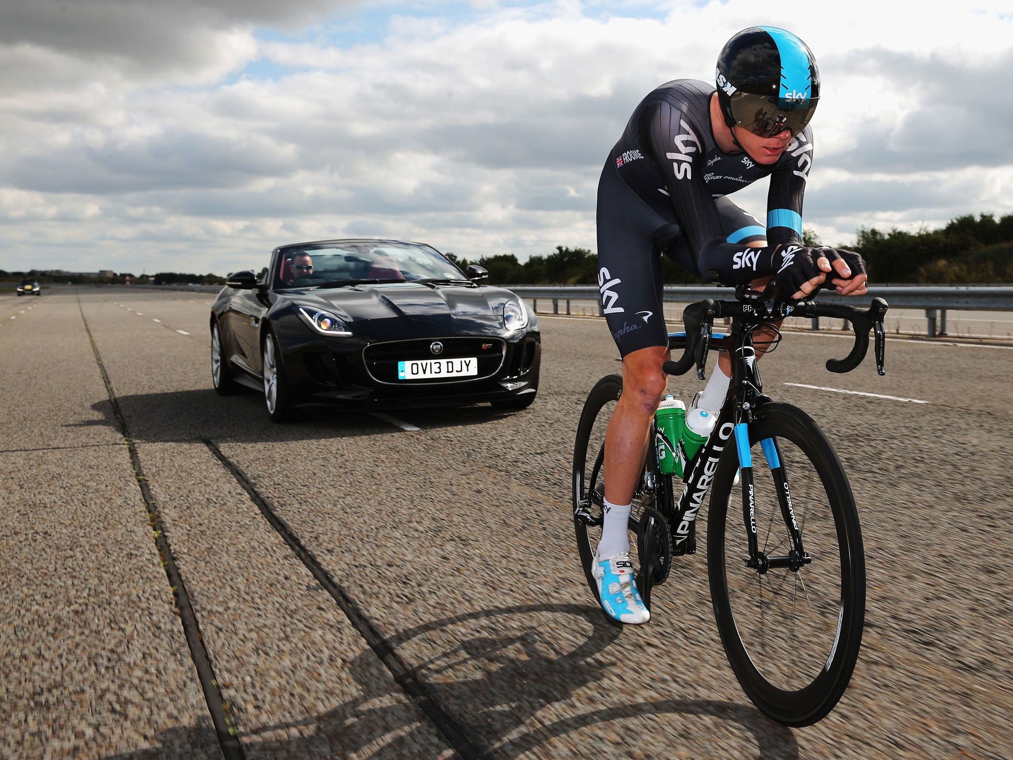 Man versus machine: Chris Froome tries a high-speed run on his Pinarello bike with a Jaguar F-Type in pursuit