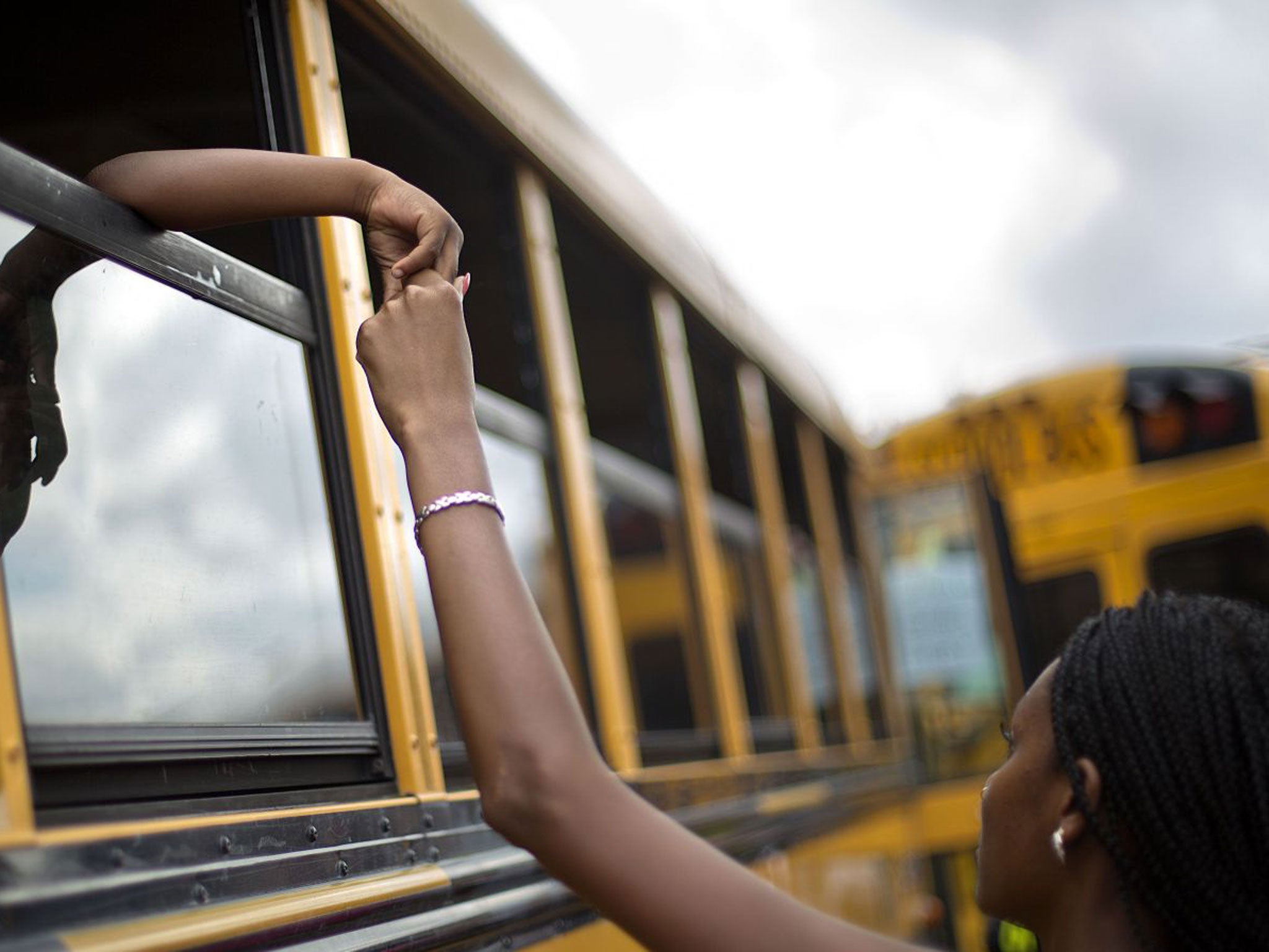 A woman is reunited with her nephew, 6, after students were evacuated on buses