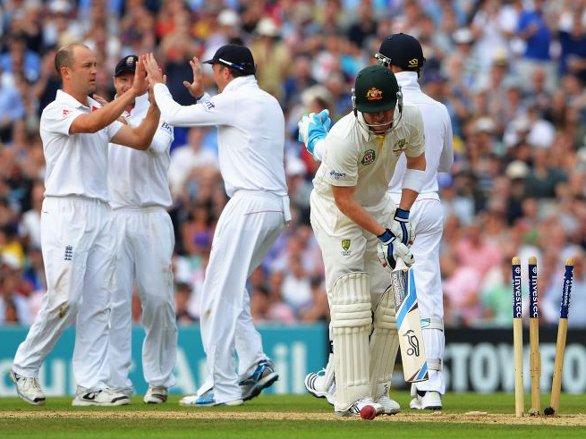 Jonathan Trott, far left, is congratulated after taking the wicket of Australia’s Brad Haddin