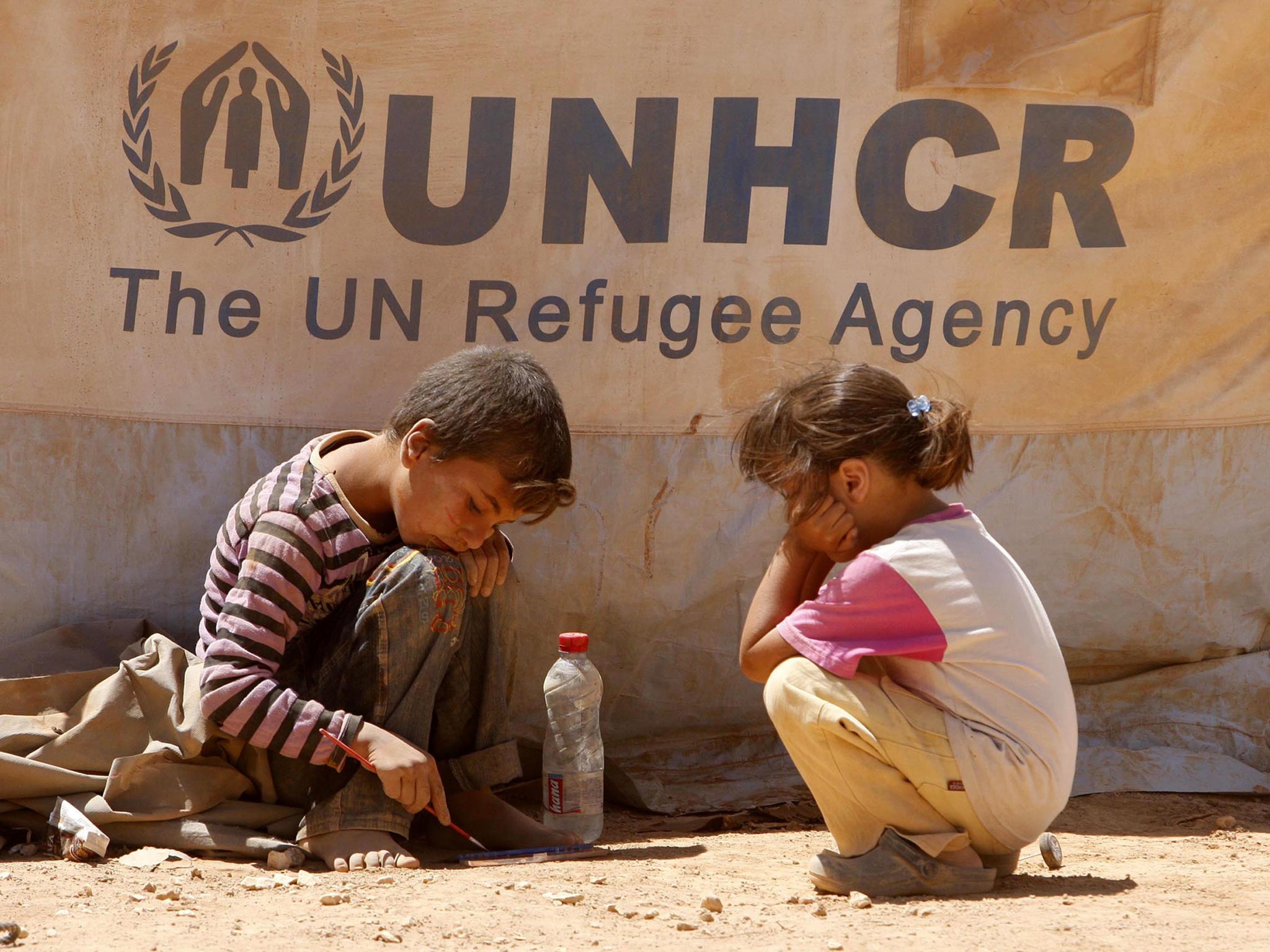 Syrian children playing in front of their tent at Zaatari Syrian refugee camp in Mafraq, Jordan