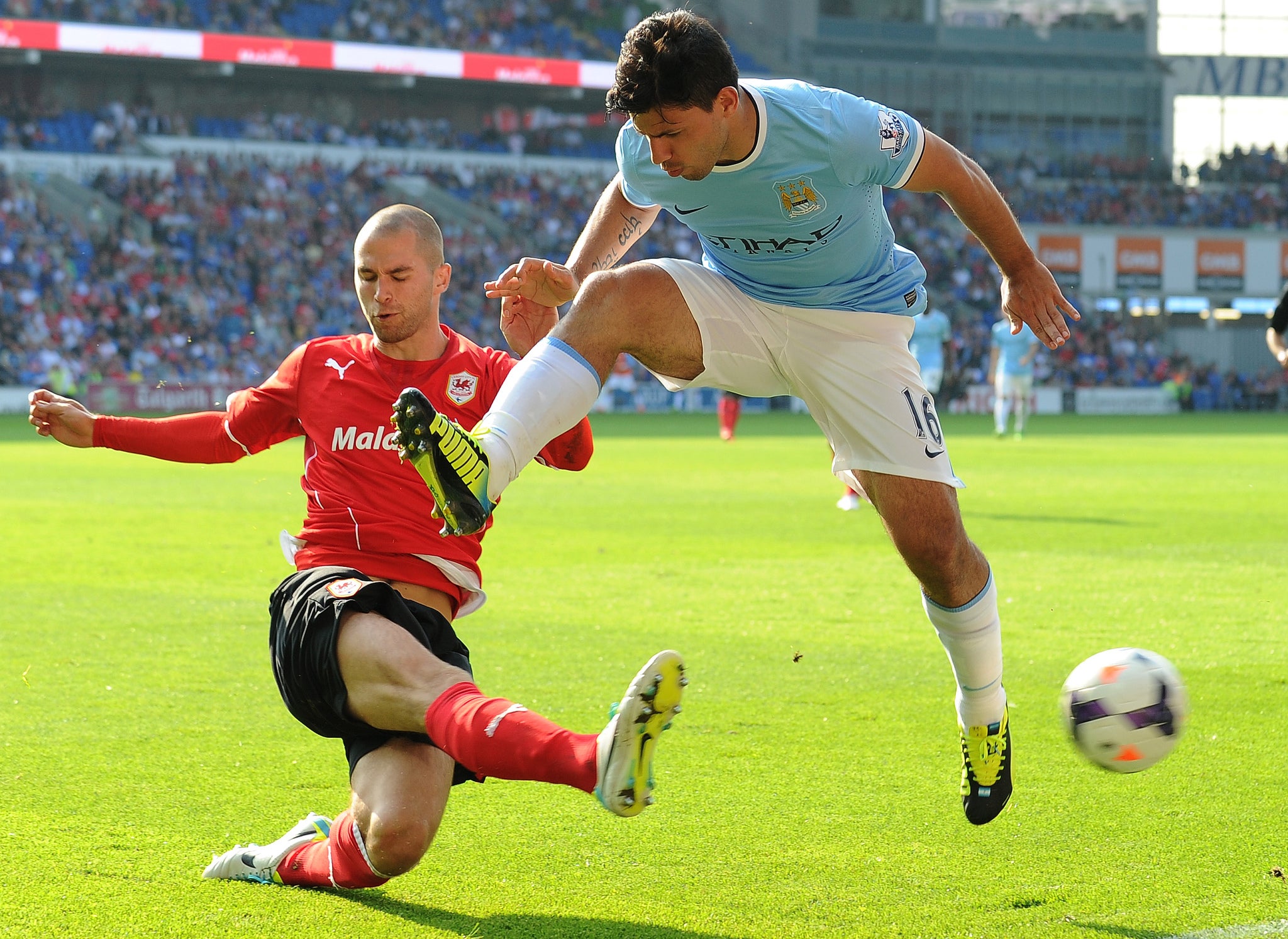 CARDIFF, WALES - AUGUST 25: Manchester City's Argentinian striker Sergio Aguero (R) vies with Cardiff City's English defender Matthew Connolly during the English Premier League football match between Cardiff City and Manchester City at The Cardiff City Stadium in Cardiff. GETTY IMAGES.