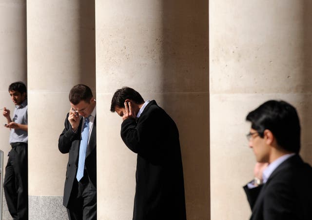 2008City workers make phone calls outside the London Stock Exchange in Paternoster Square in the City of London at lunchtime October 1, 2008.