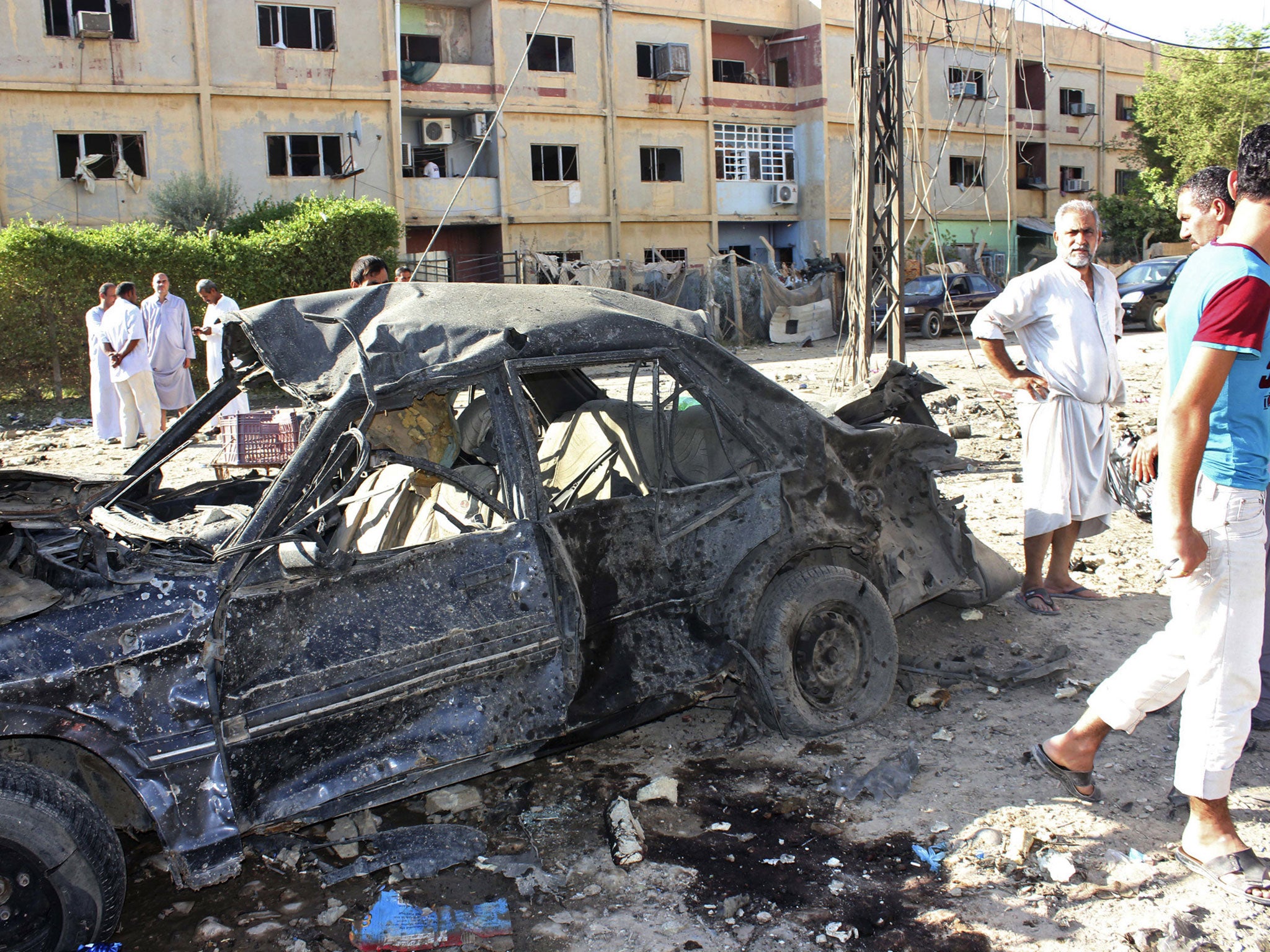 Locals gather at the site of a bomb attack in Baquba, about 50 km (30 miles) north east of Baghdad on Sunday