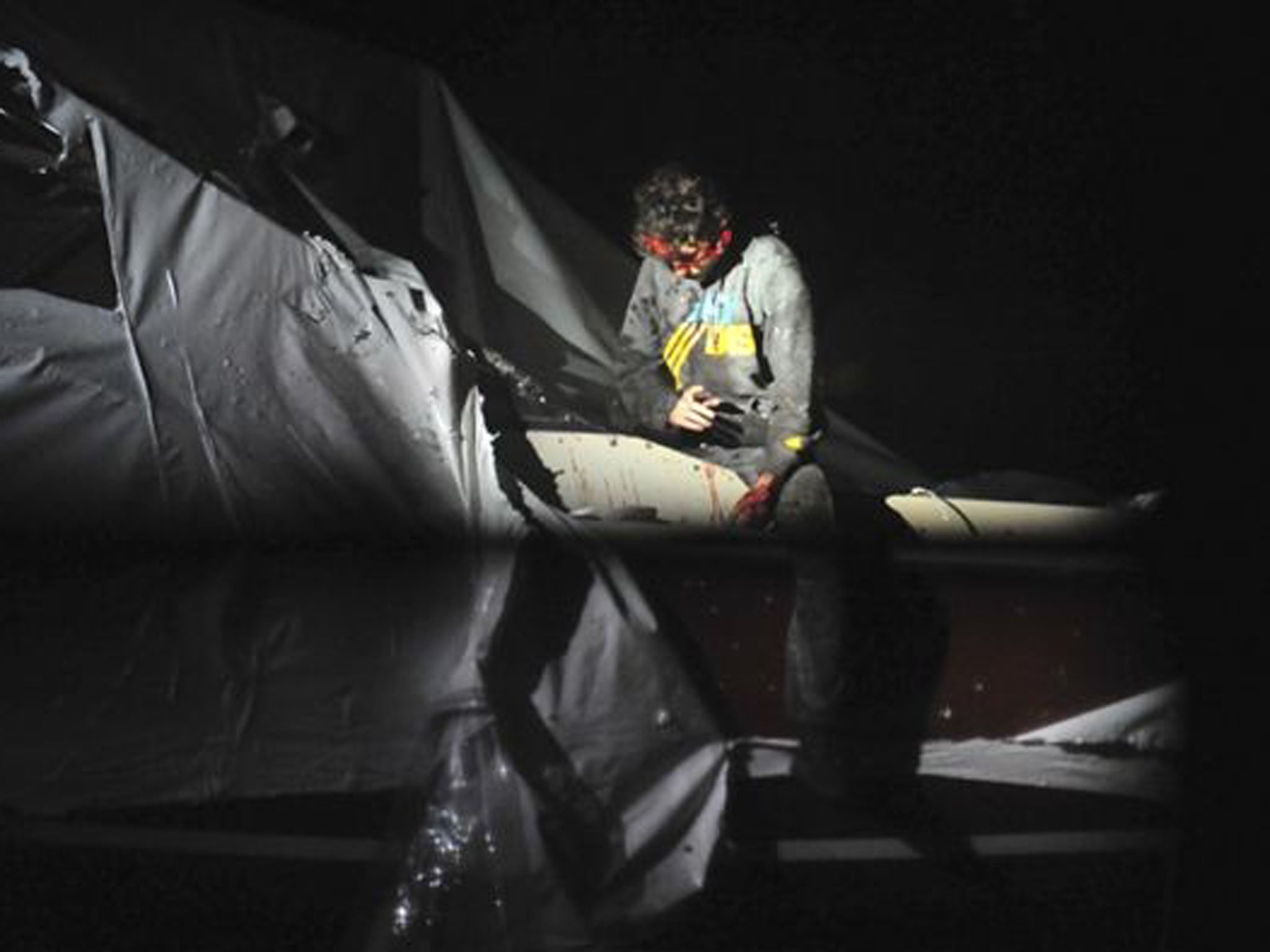 The bloodied Boston Marathon bombing suspect as he leaves the boat