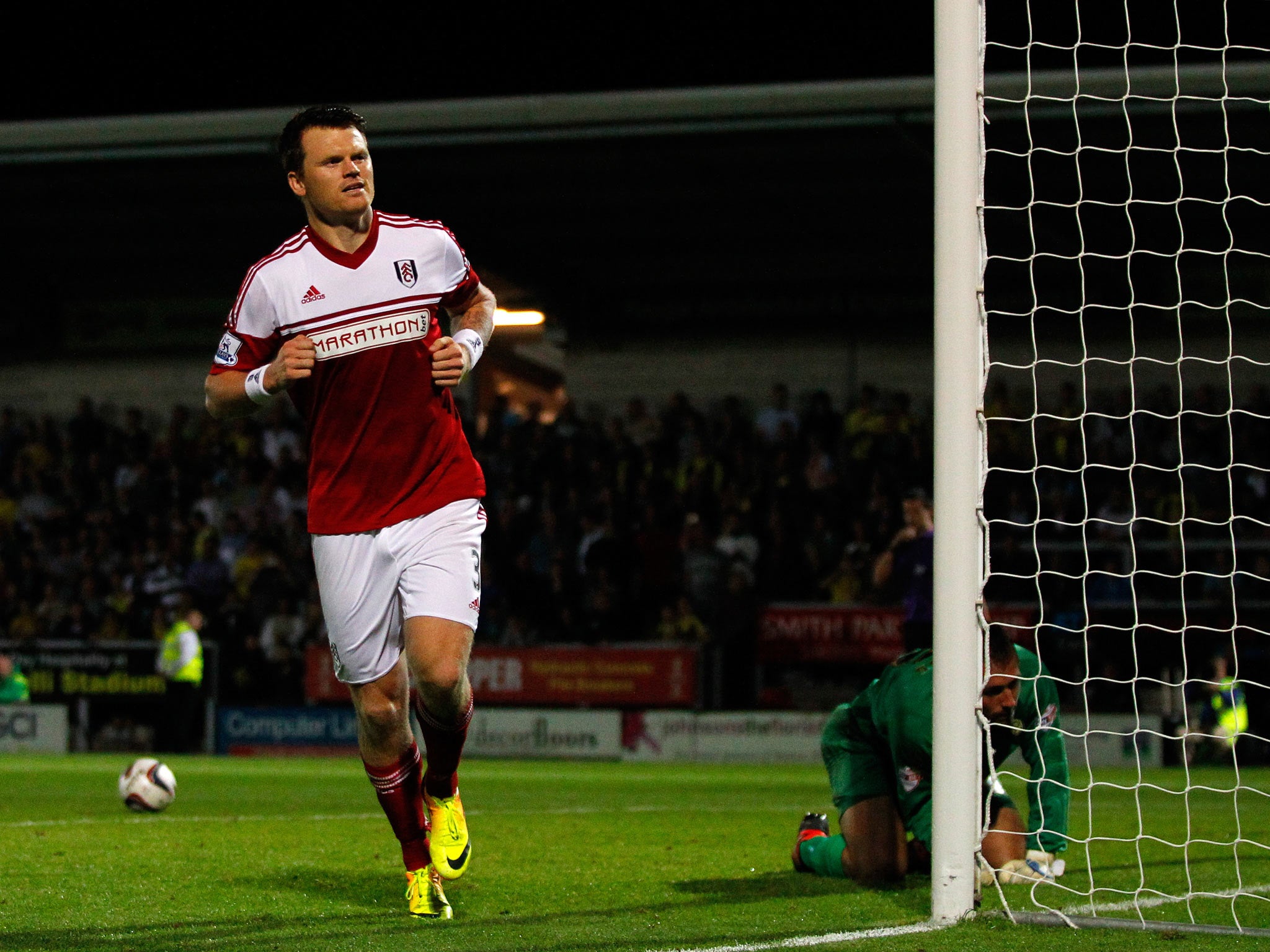 John Arne Riise of Fulham celebrates after scoring the winning penalty against Burton