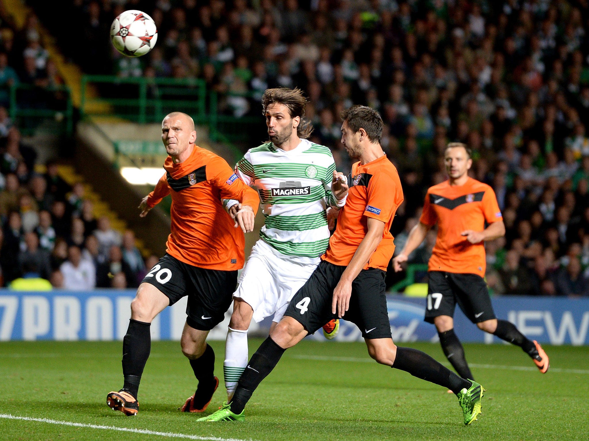 Giorgos Samaras tackles Aldin Dzidic and Nikola Vasiljevic of Shakhter Karagandy