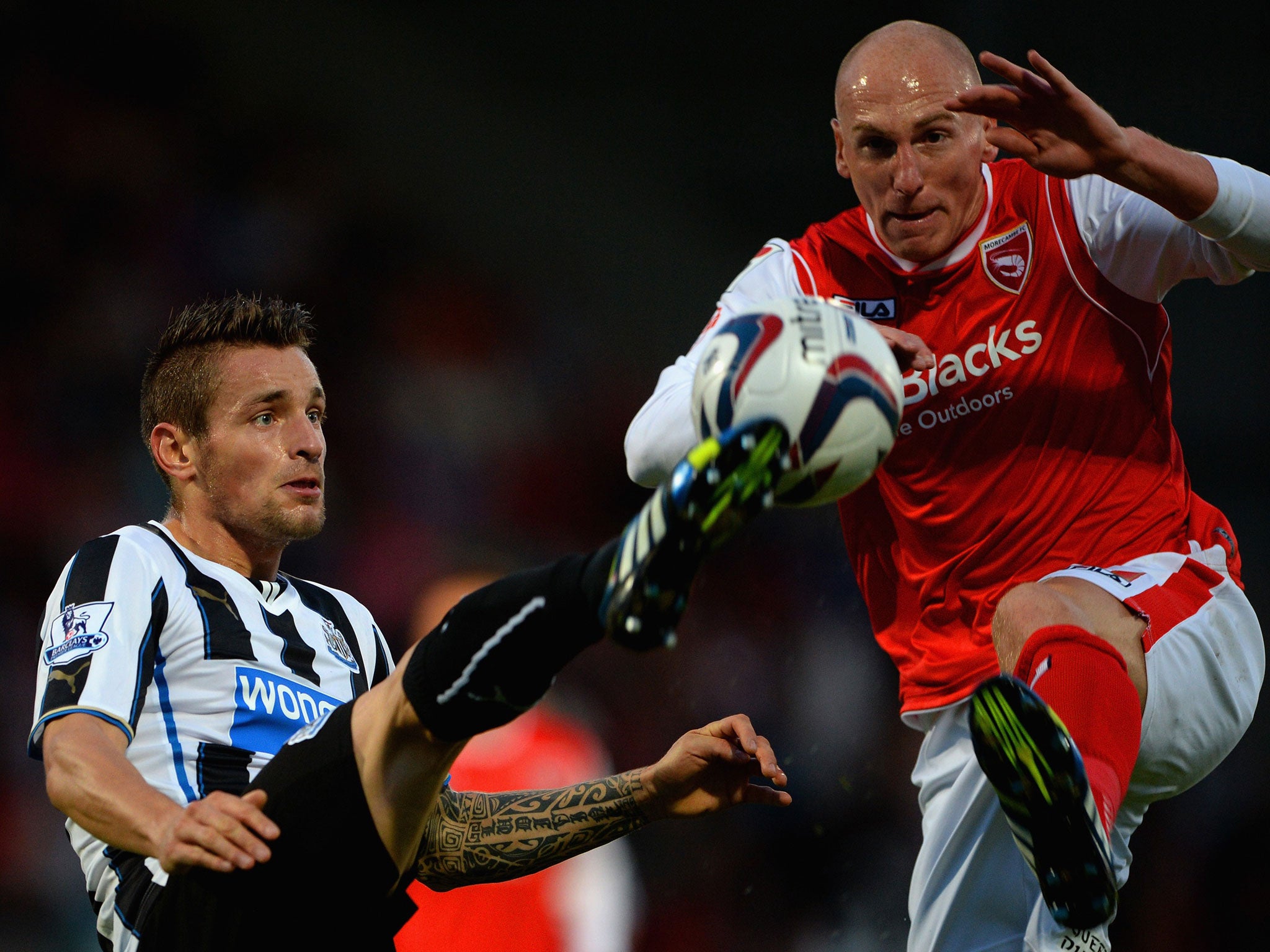 Mathieu Debuchy of Newcastle and Morecambe's Kevin Ellison