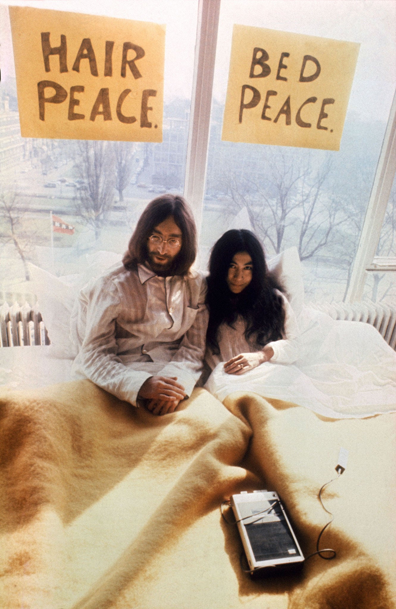 John Lennon and Yoko Ono on honeymoon in Amsterdam, spending a week in bed at the Hilton Hotel to protest against world violence in 1969