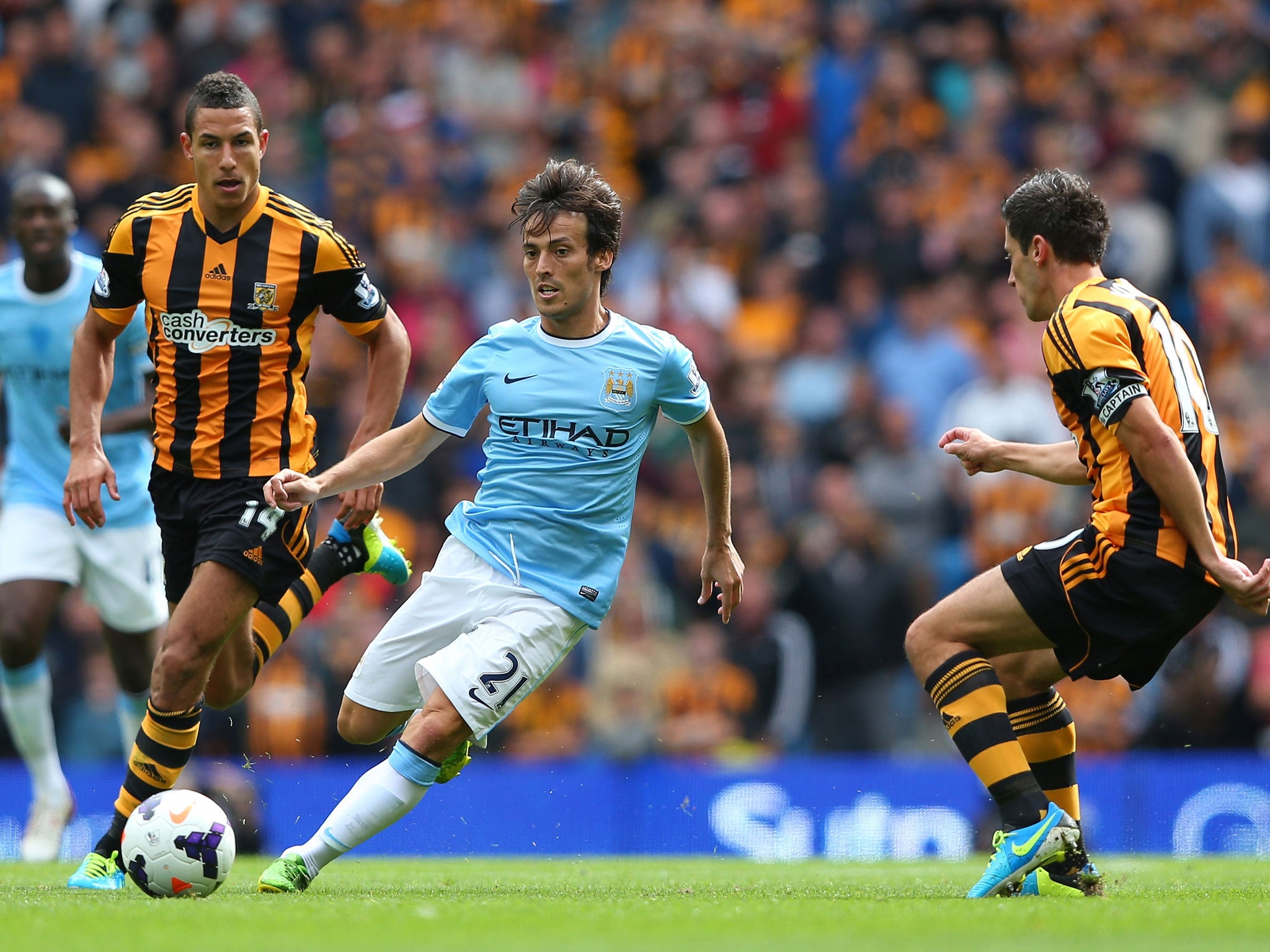 David Silva of Manchester City beats Robert Koren and Jake Livermore of Hull