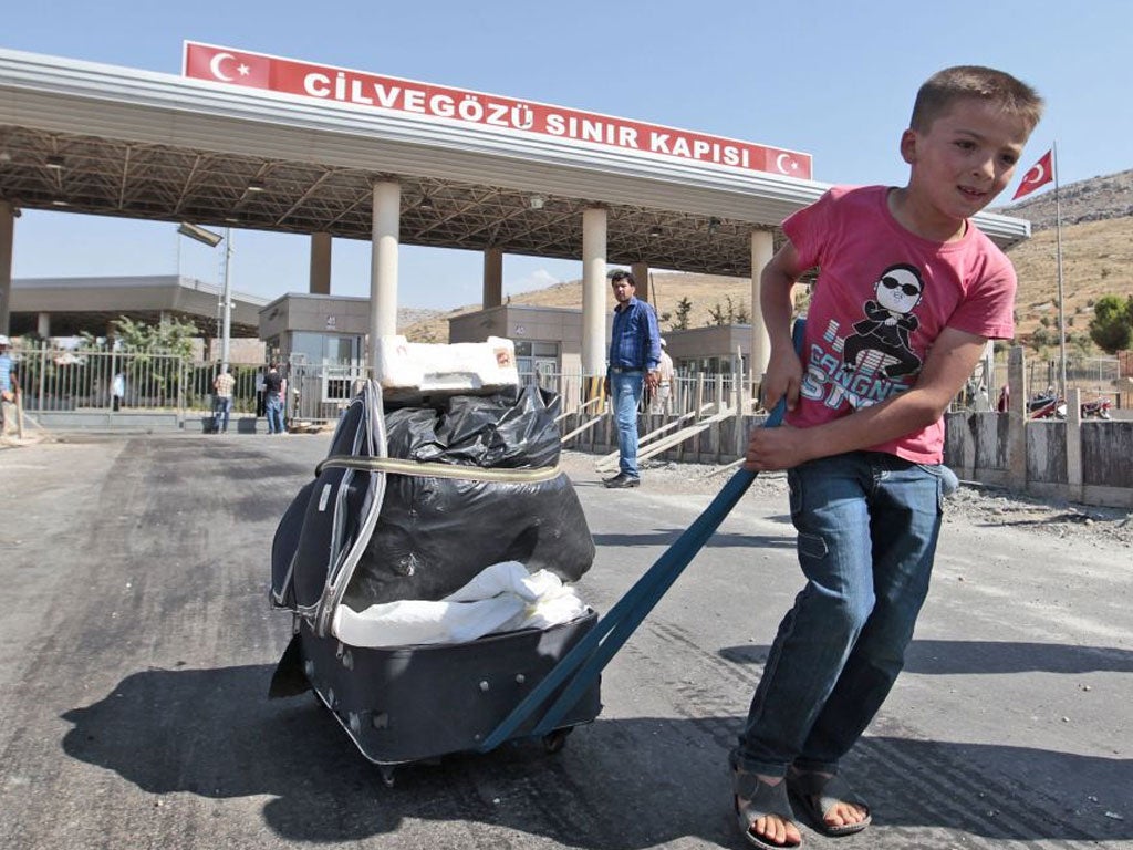 A Syrian boy at the Turkish border. Now refugees are making for Lebanon