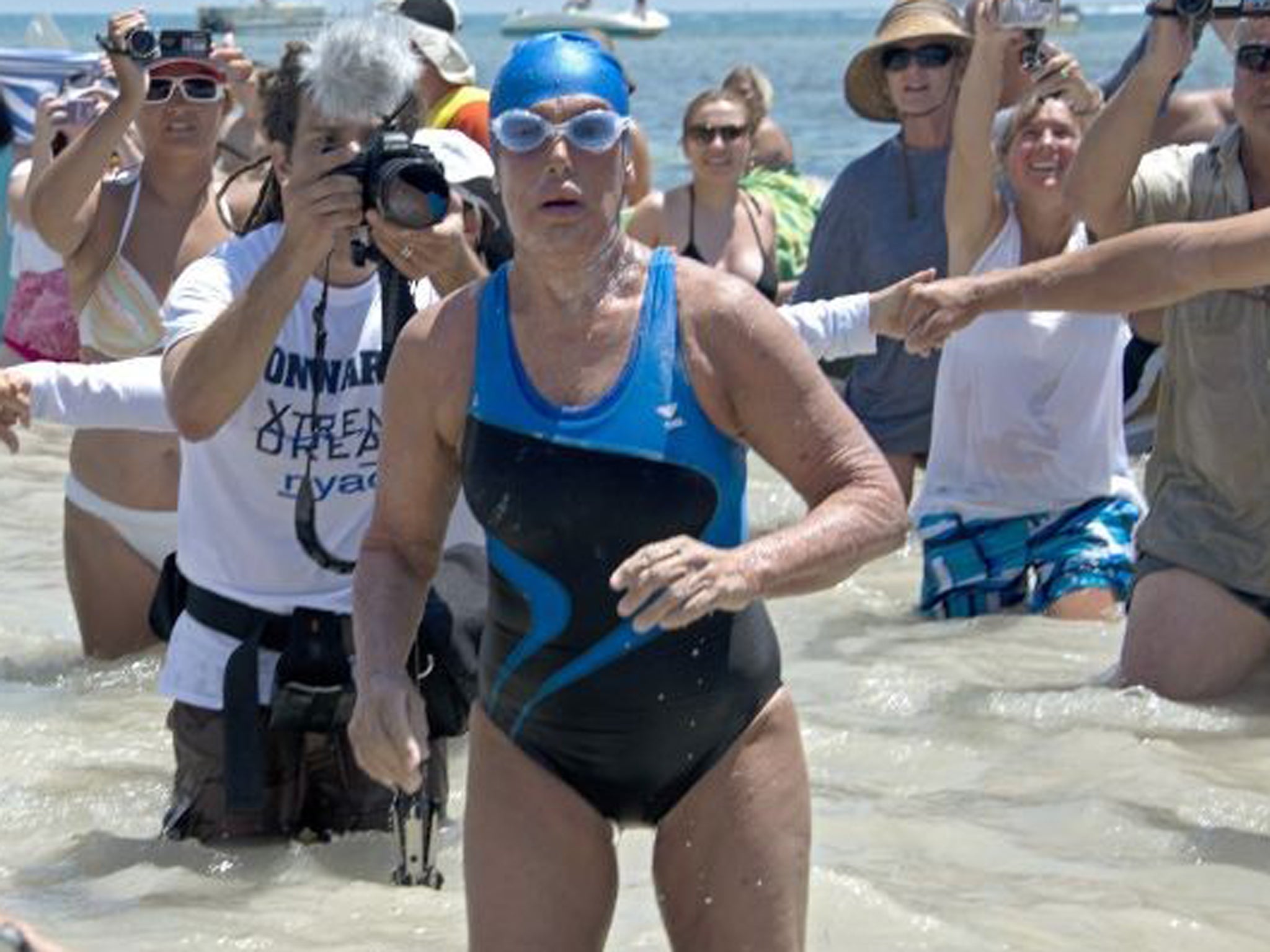 Diana Nyad emerges from the Atlantic Ocean after completing the 111-mile swim