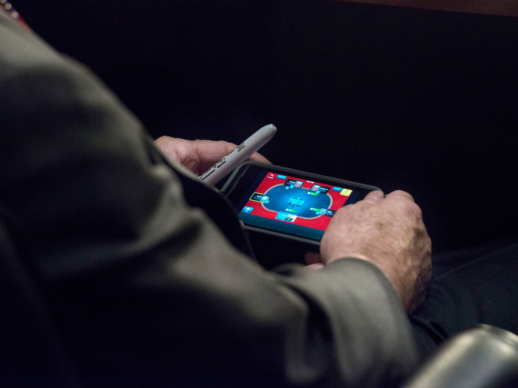 Washington Post photographer Melina Mara caught Mr McCain in the act with an over-the-shoulder picture showing the 77-year-old gambling with fake money on his phone