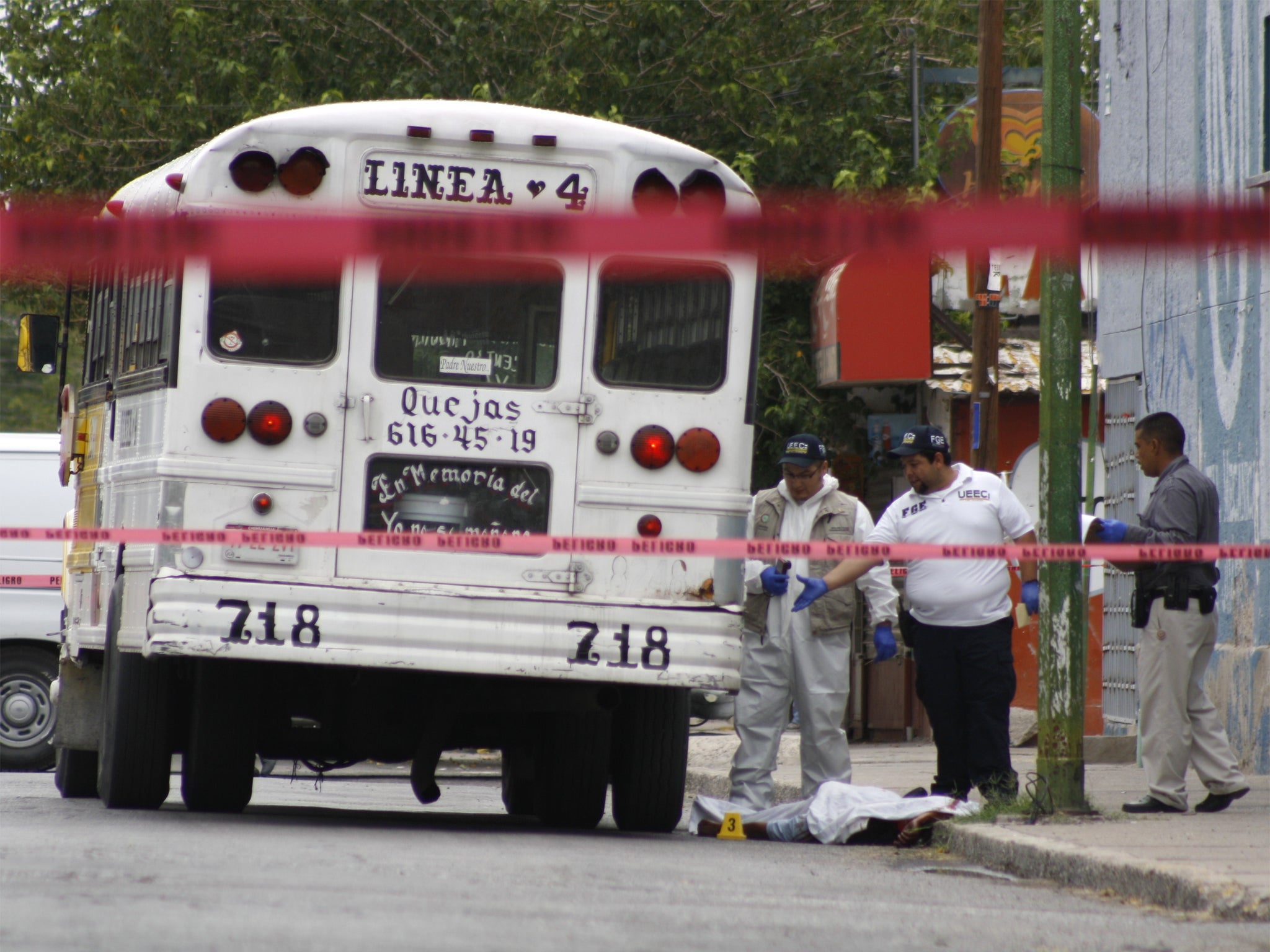 A forensic team examine the bus