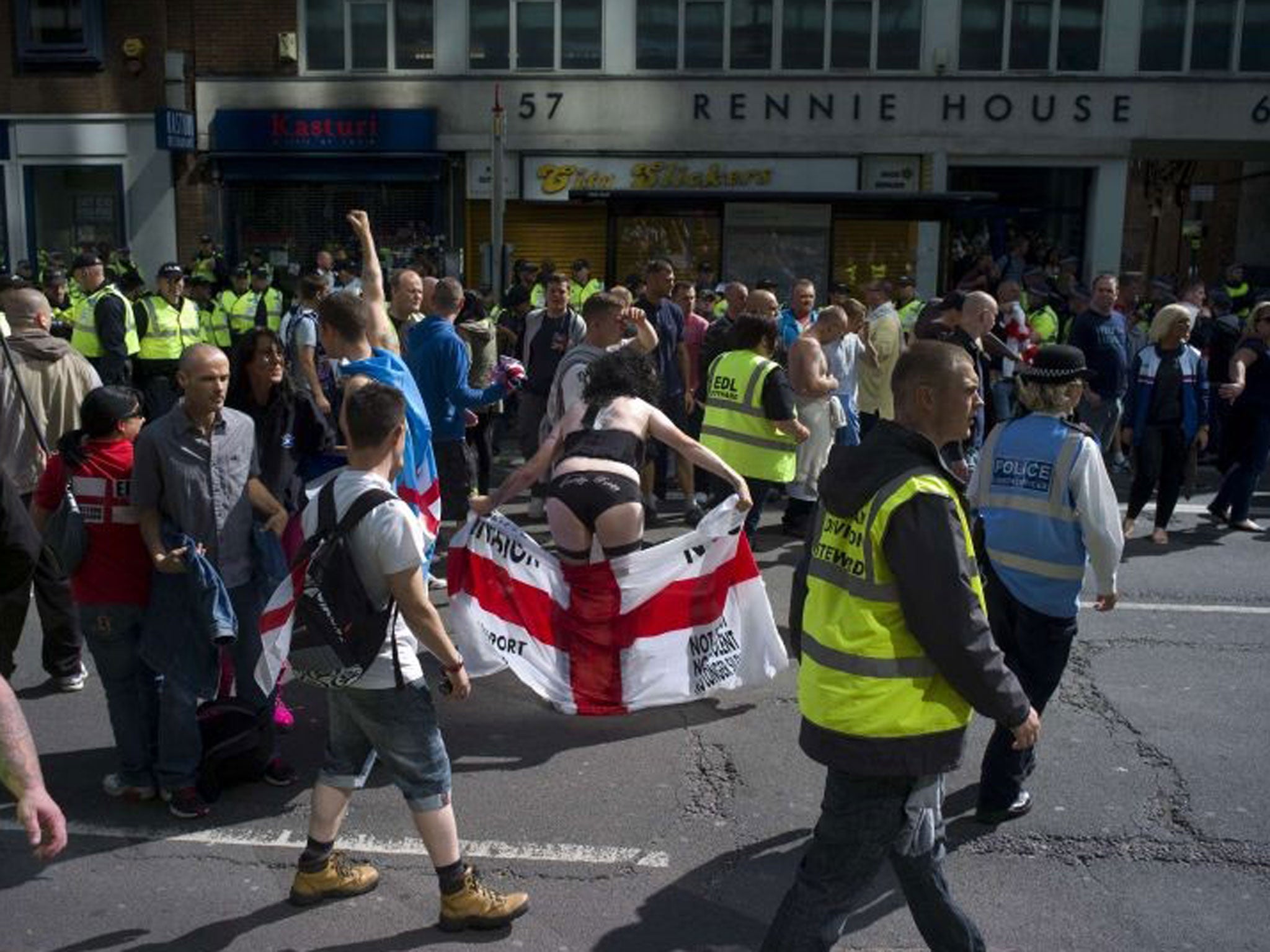 A cross-dressed member of the EDL poses during a rally in London, 7 September 2013