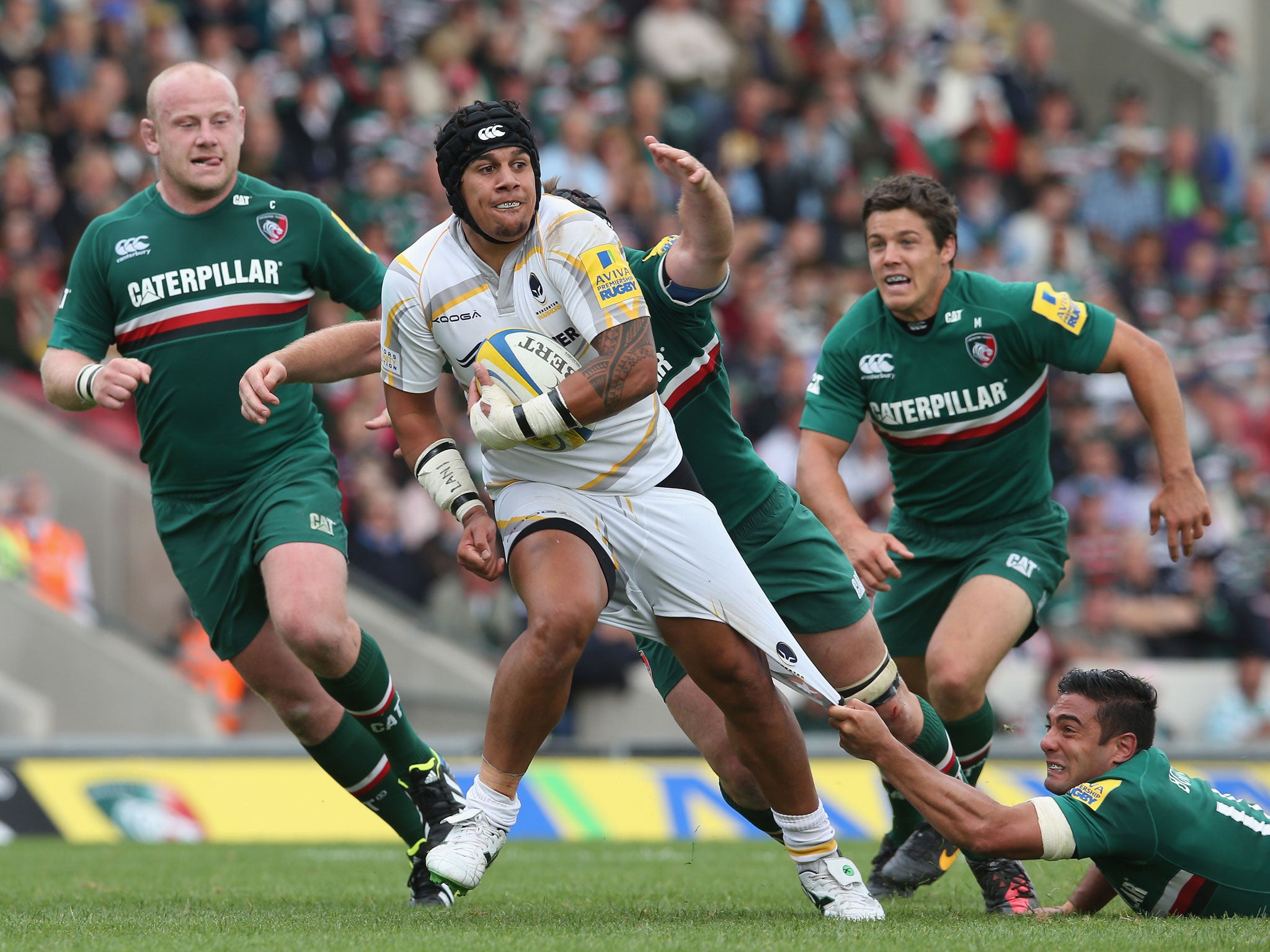 Leicester’s Dan Bowden hangs on to Josh Matavesi’s shorts at Welford Road