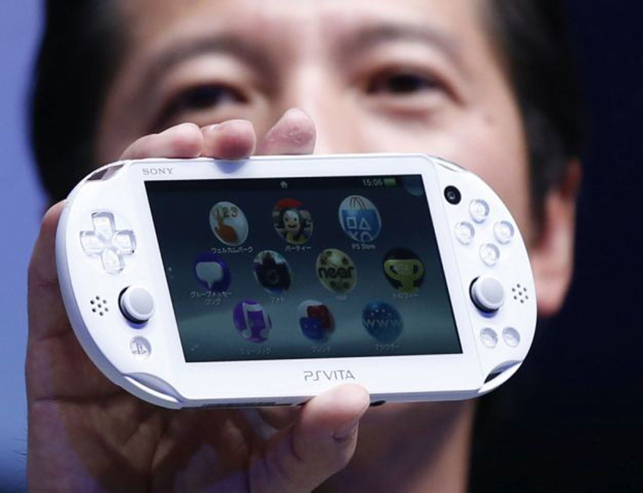 Sony Computer Entertainment Japan Asia President Hiroshi Kawano with the new PlayStation Vita