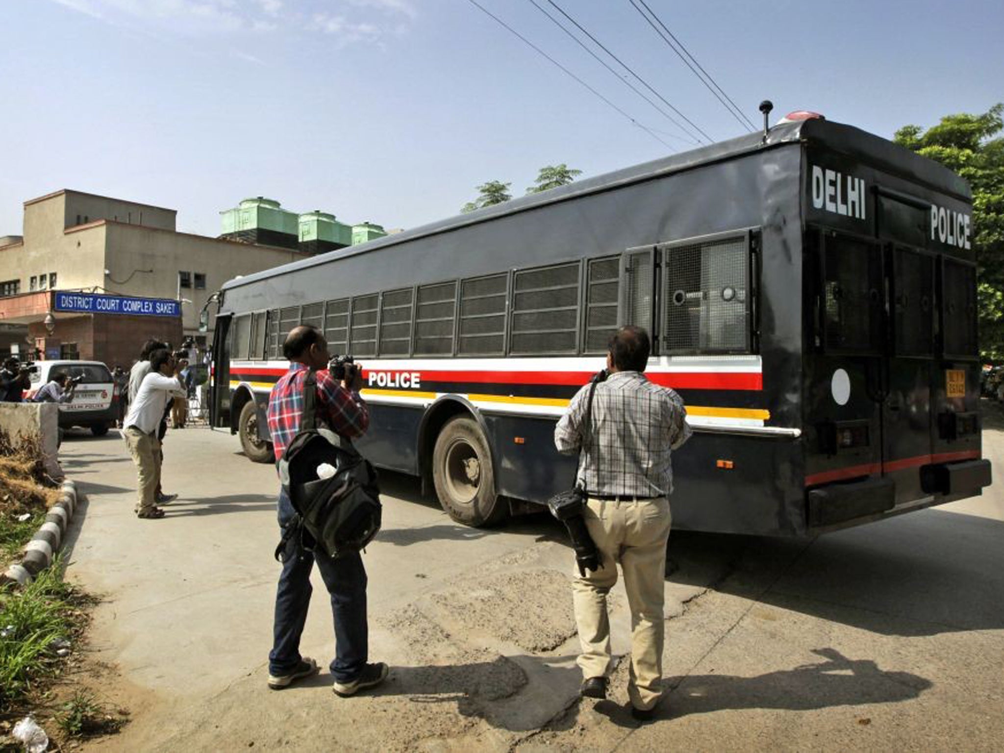 A van carrying the four men accused in the fatal gang rape of the young woman last year arrives at a court in New Delhi