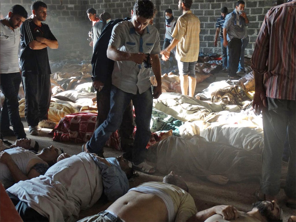 People inspect bodies of children and adults allegedly killed in a toxic gas attack in eastern Ghouta, on the outskirts of Damascus, last month (Getty)