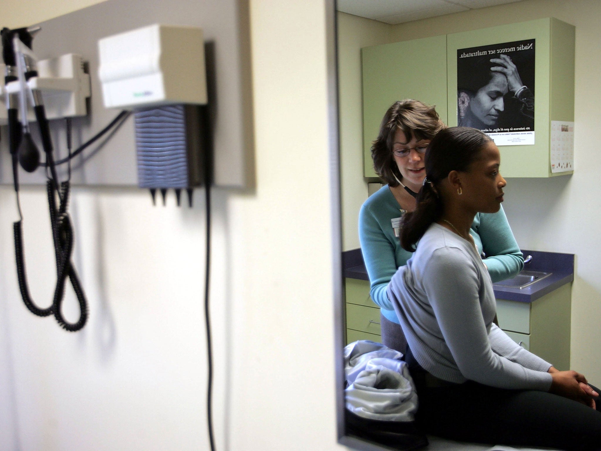 A doctor uses a stethoscope during an examination of a patient.