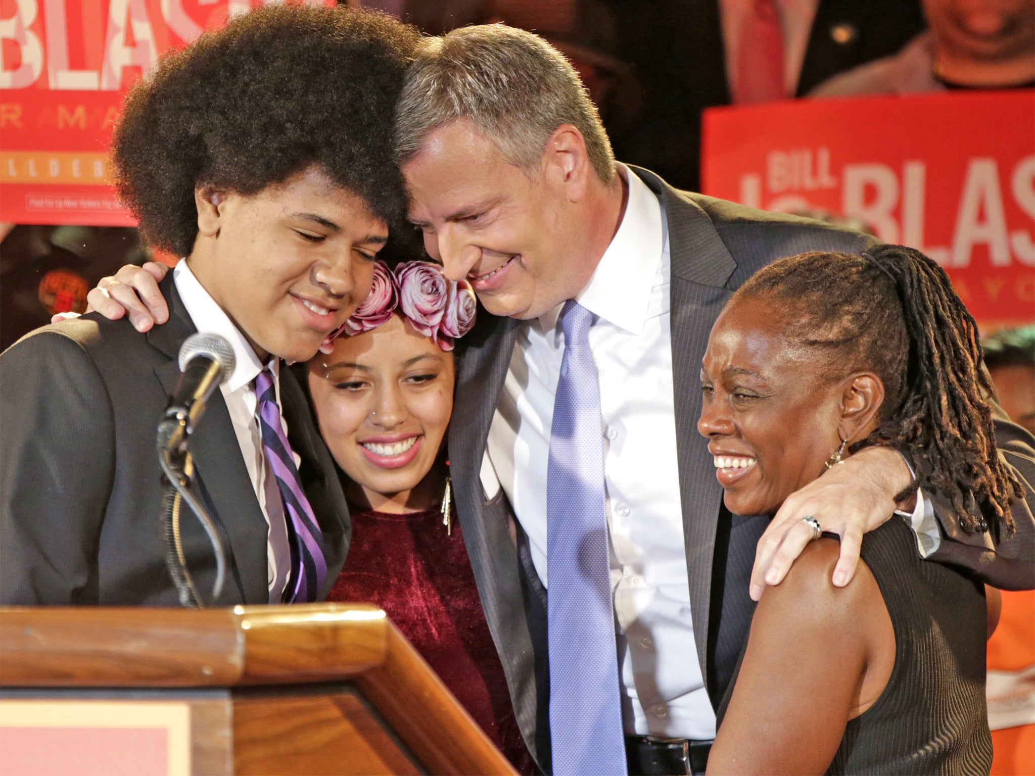 Bill De Blasio embraces his son Dante, left, daughter Chiara and wife Chirlane, right, after his win