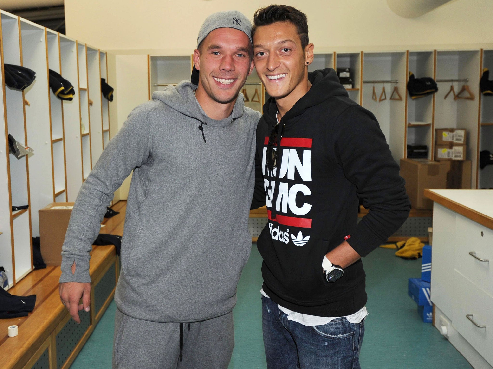 Ozil poses with his Germany team-mate Podolski