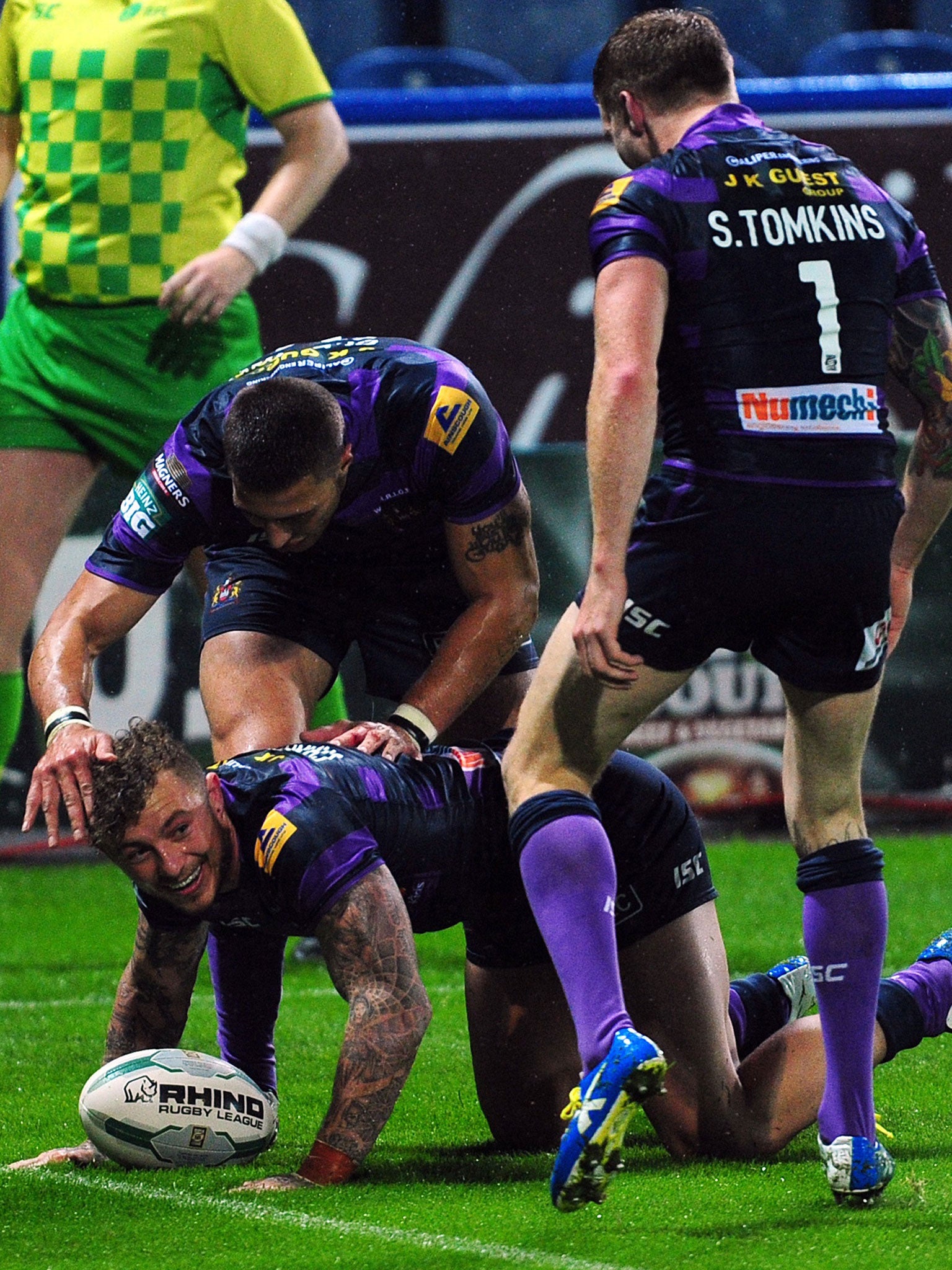 Wigan Warriors' Josh Charnley celebrates with Anthony Gelling and Sam Tomkins after scoring a try during the Super League Elimination Play Off