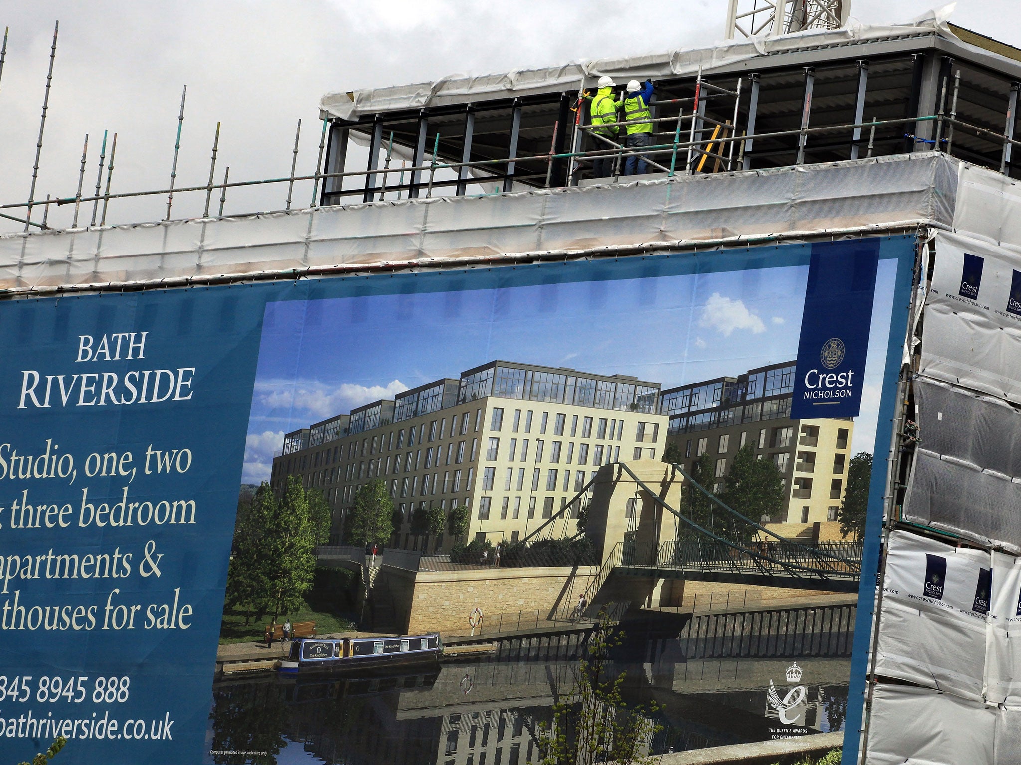 Cladding surrounds a new block of apartments and flats being built on a development on April 26, 2012 in Bath, England.