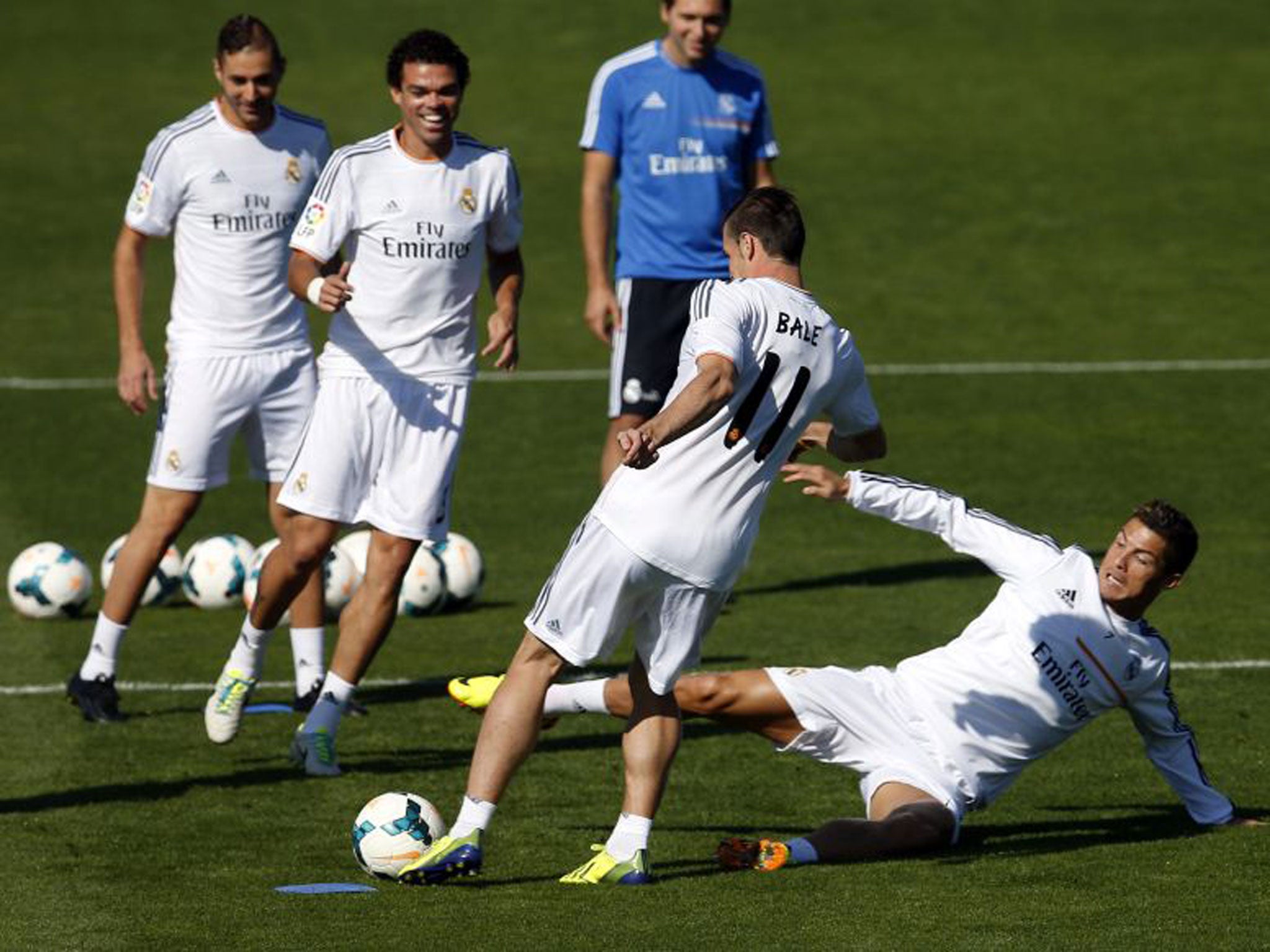 Cristiano Ronaldo gives Gareth Bale, his new Real Madrid team-mate, a warm welcome in training with a friendly, sliding, studs-up tackle