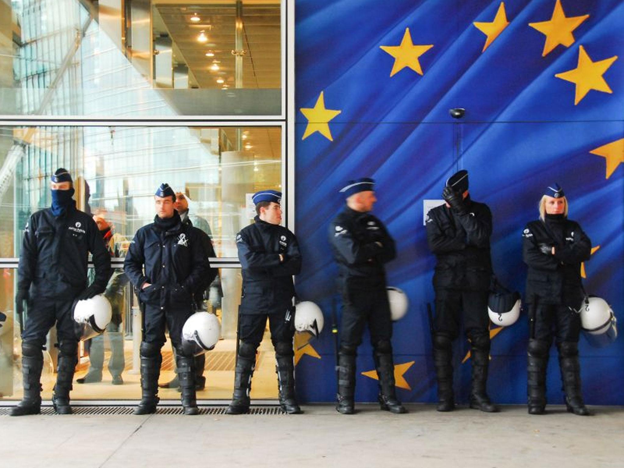 Police presence: Officers stand guard at the Europol conference at The Hague (Euro)