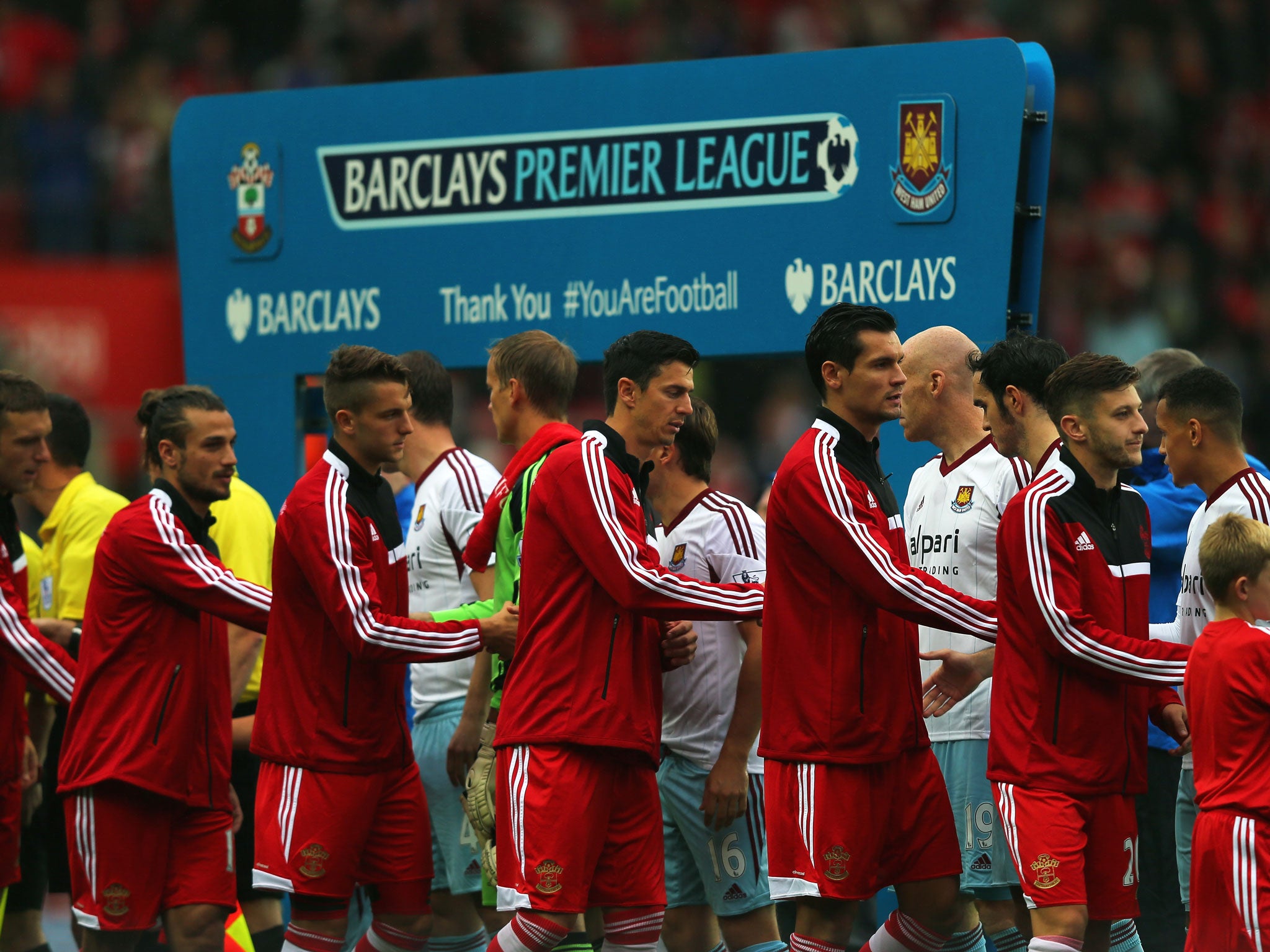 The opposing players shake hands prior to kickoff