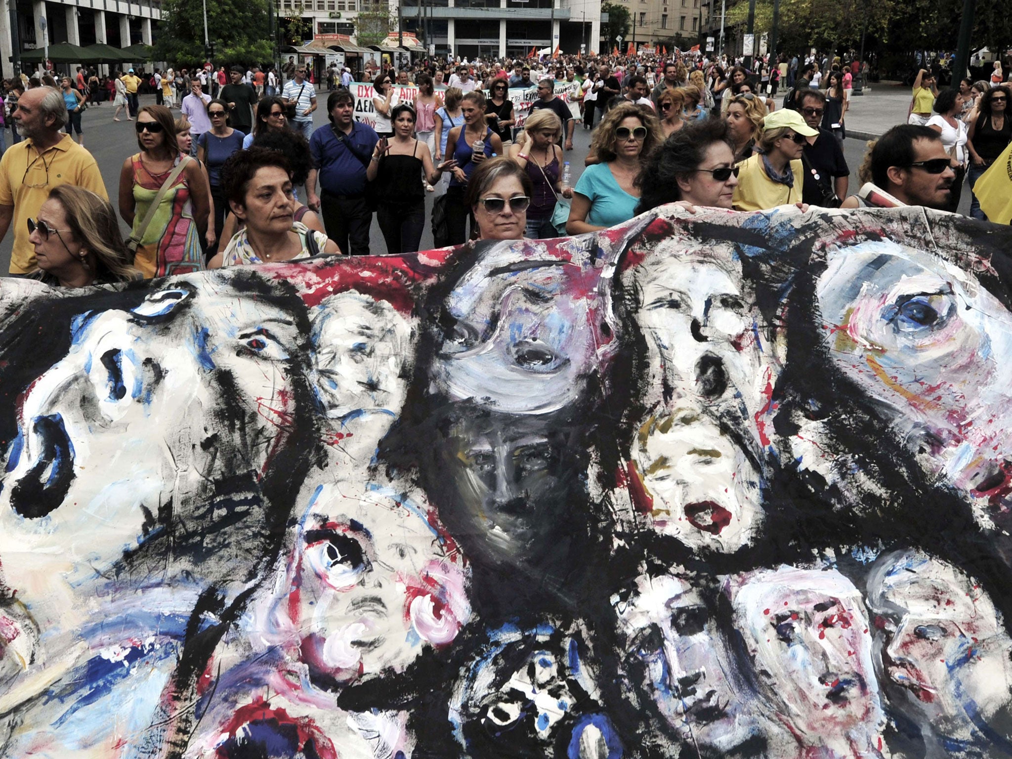 Greek teachers hold a banner during a protest in Athens