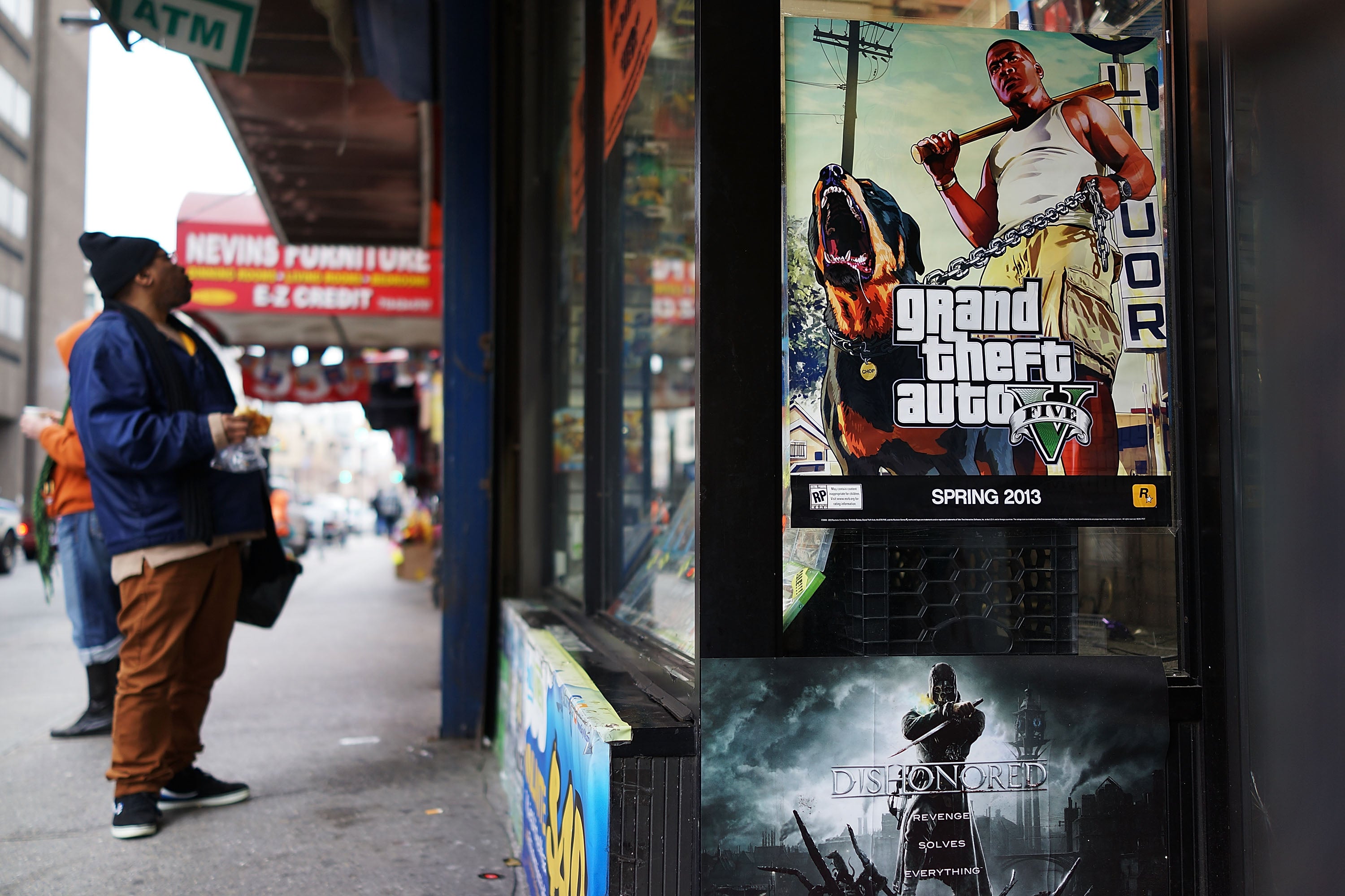 An advertisement for the new Grand Theft Auto is displayed outside of a gaming store on January 11, 2013 in New York City.