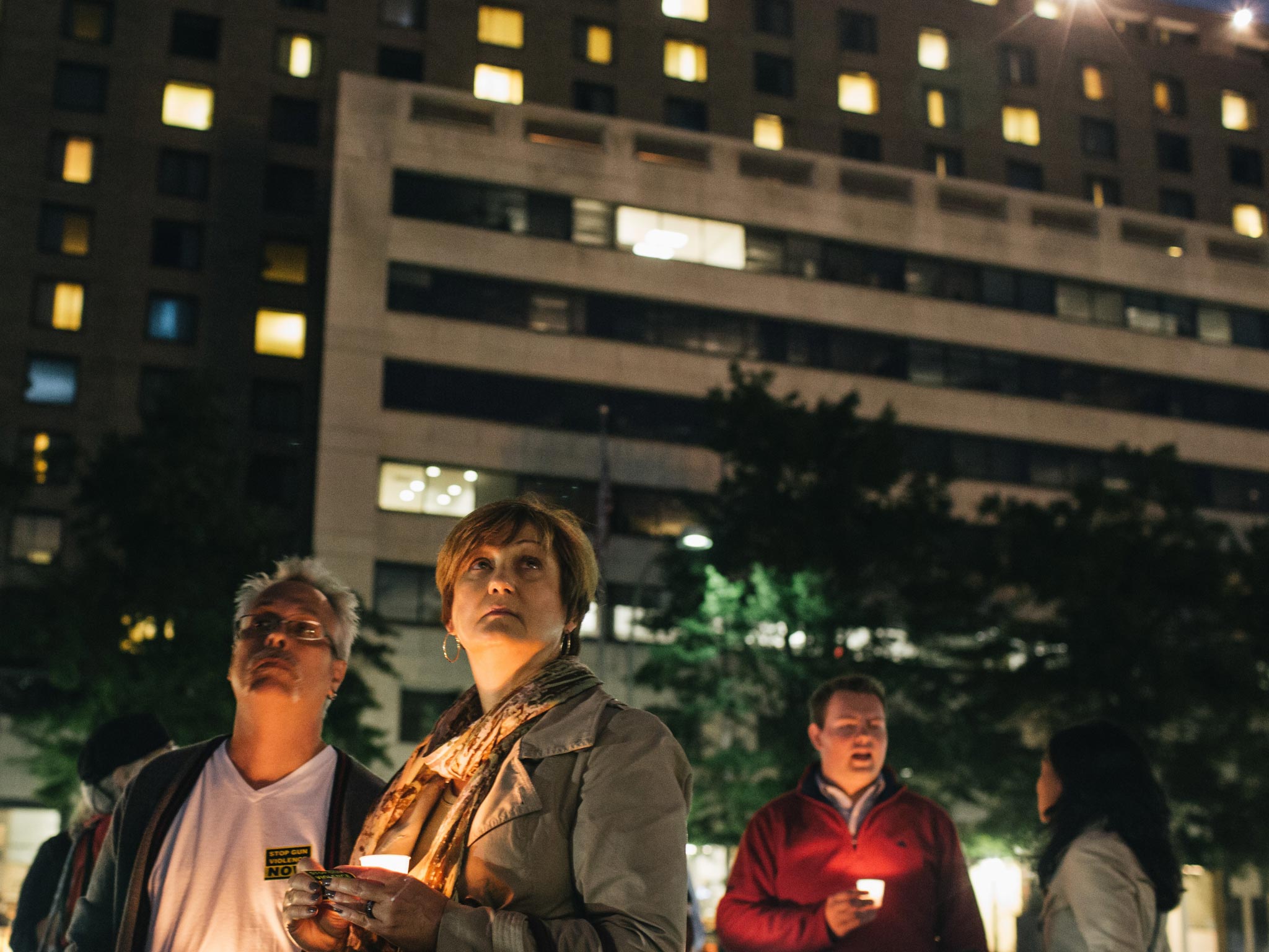 Gordon Morris (L) and wife Laura watch as the flags are lowered to half mast during a vigil at Freedom Plaza