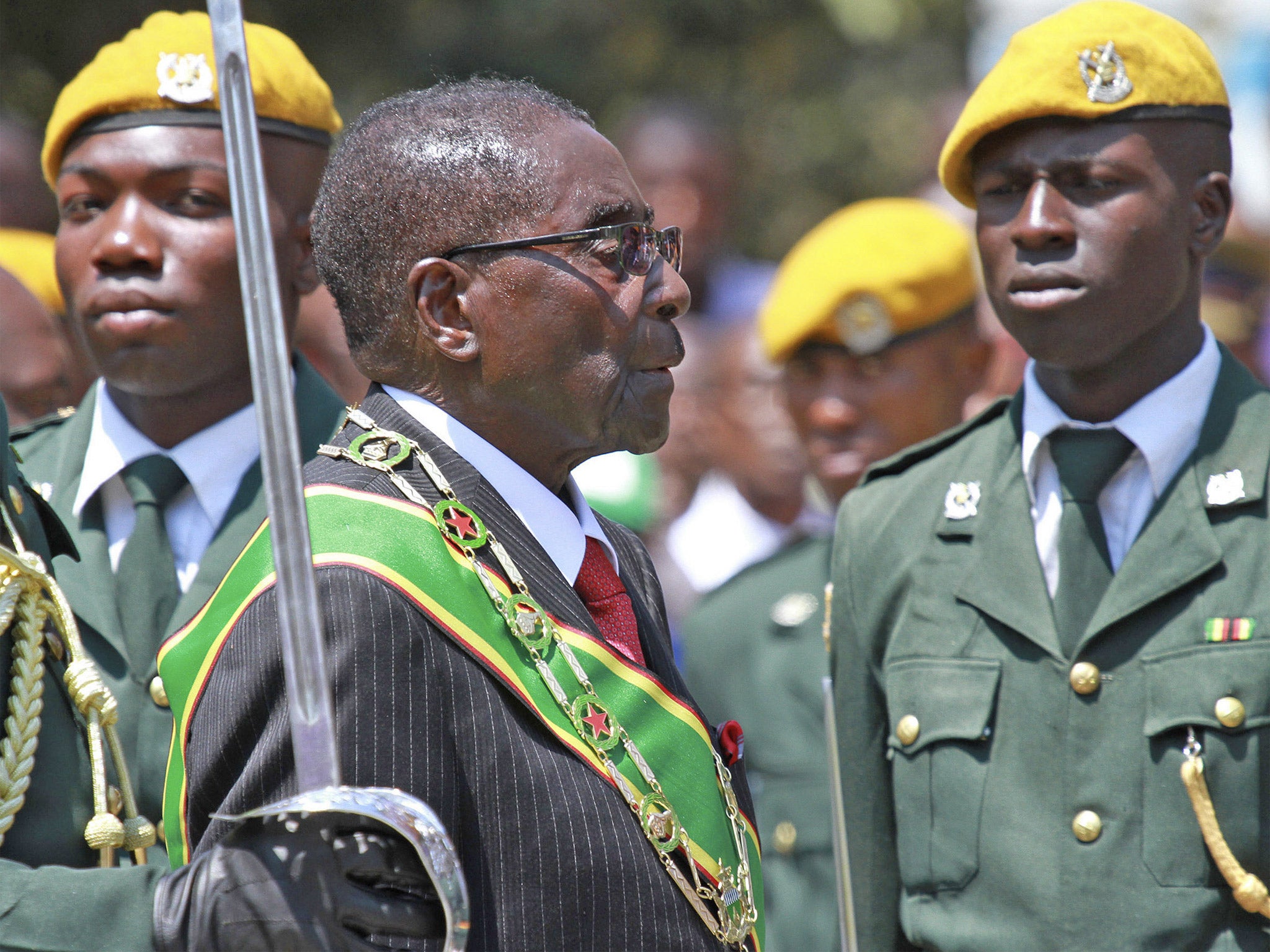 Zimbabwean President Robert Mugabe inspects the guard of honour during the parliamentary ceremony