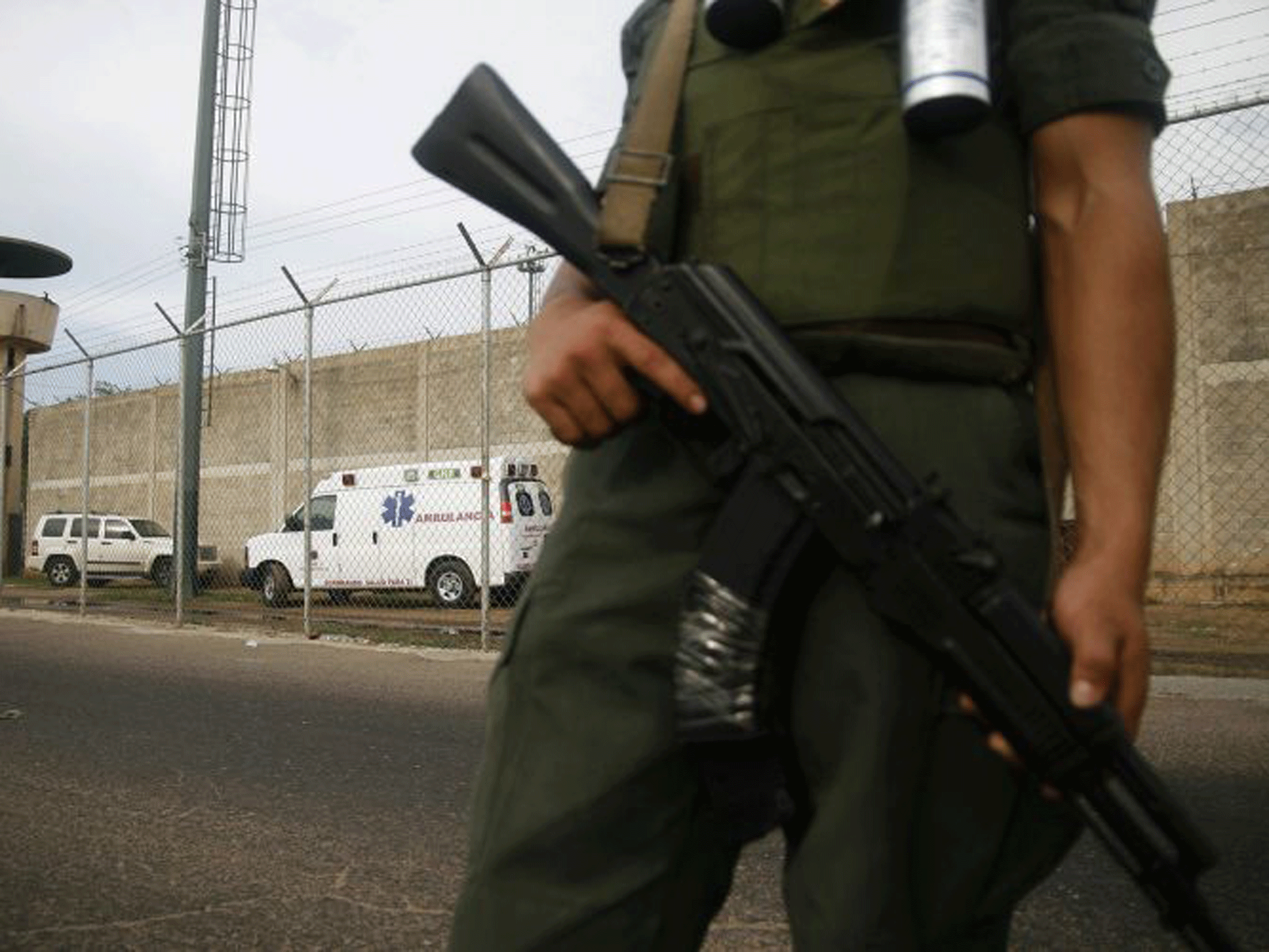 An armed guard outside the prison in Sabaneta in Zulia state, Venezuela, where 16 inmates died during a gang battle