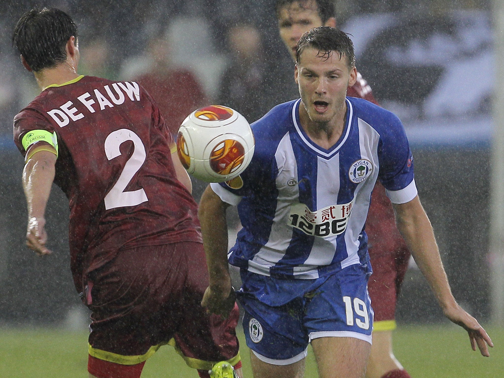 Wigan’s Nick Powell tries to get past Davy de Fauw in Bruges