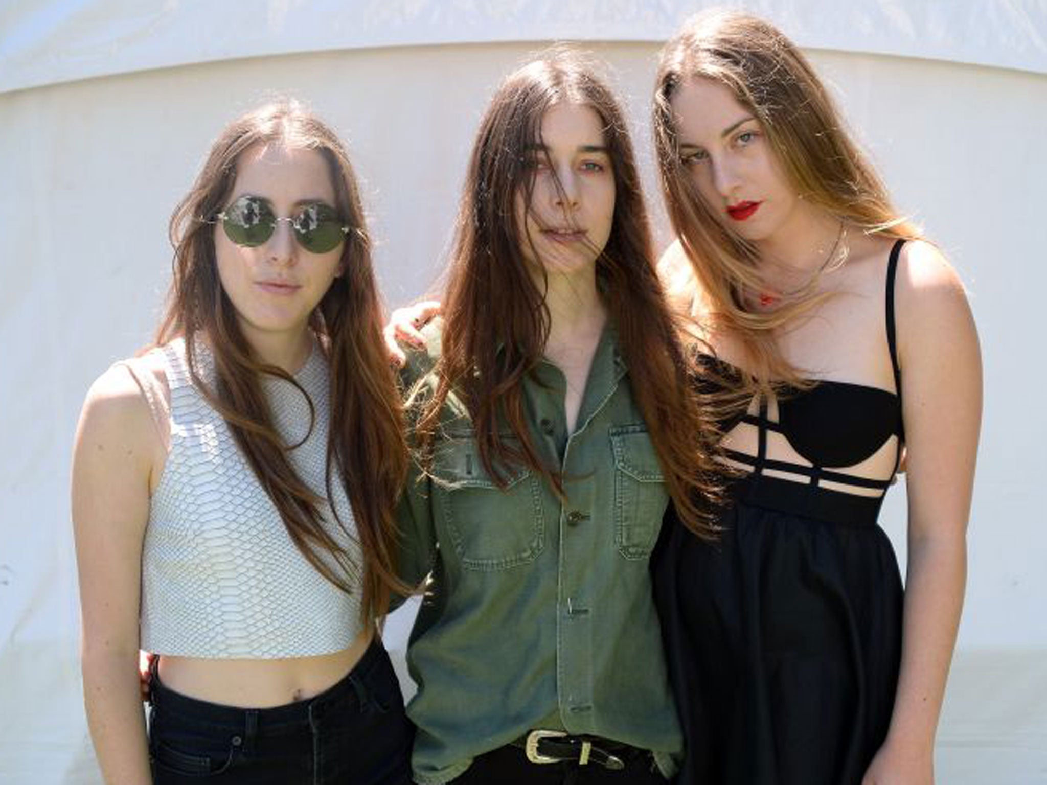 Este Haim, Danielle Haim and Alana Haim of HAIM pose backstage during Lollapalooza 2013 in Chicago