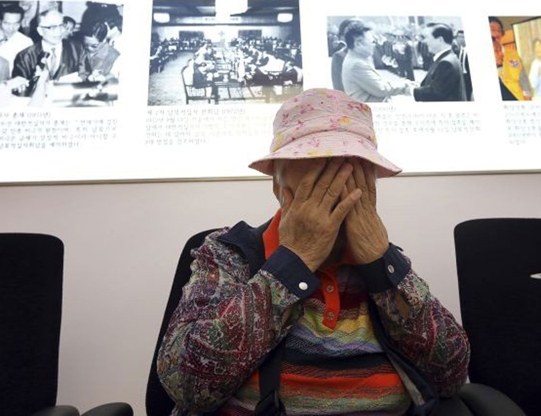 South Korean Cho Jang-geum, 81, weeps as she fills out an application form to reunite with her family members who are living in North Korea