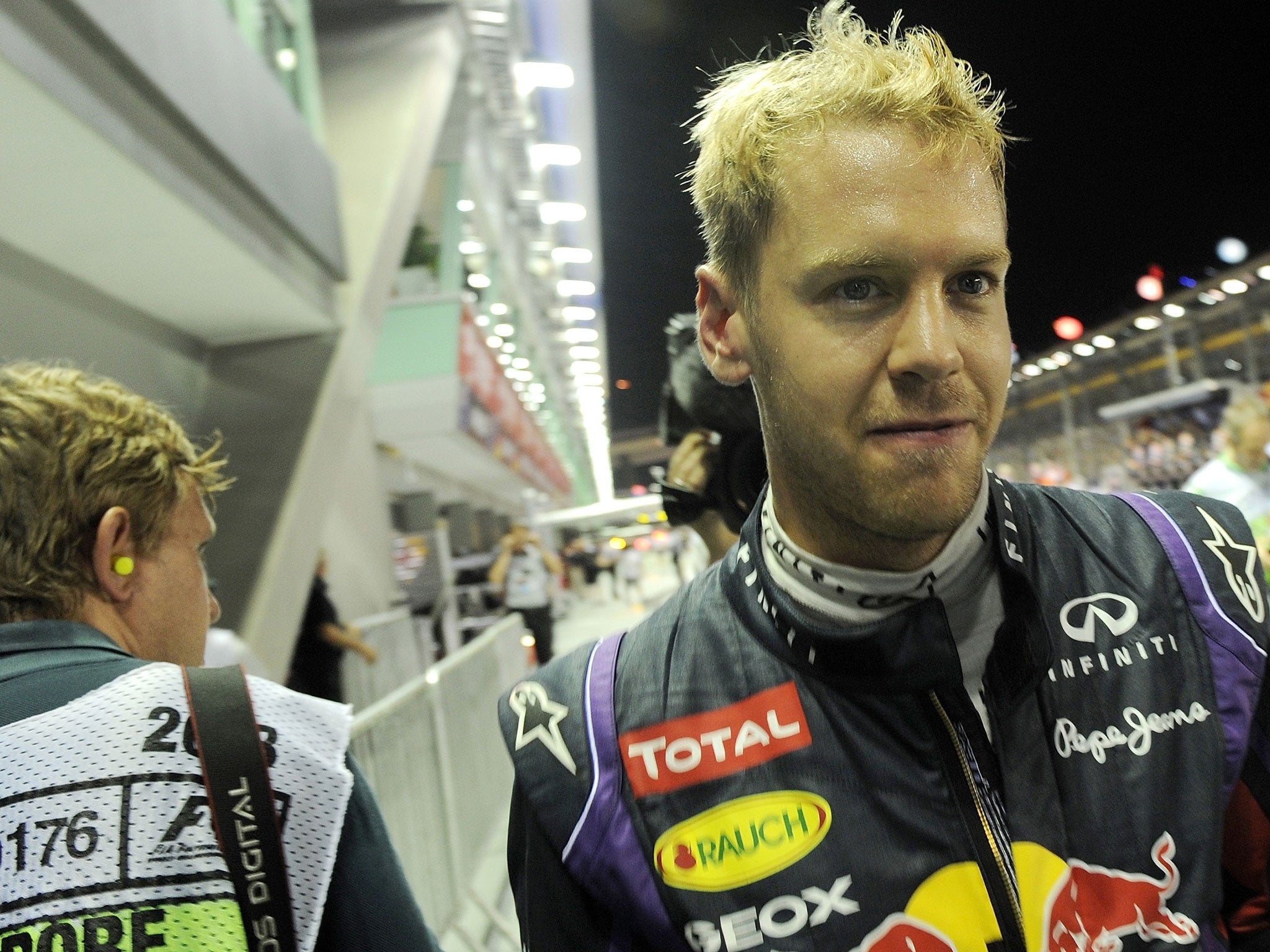 SINGAPORE - SEPTEMBER 21: Red Bull driver Sebastian Vettel of Germany celebrates his pole position after the qualifying session of the Formula One Singapore Grand Prix. GETTY IMAGES